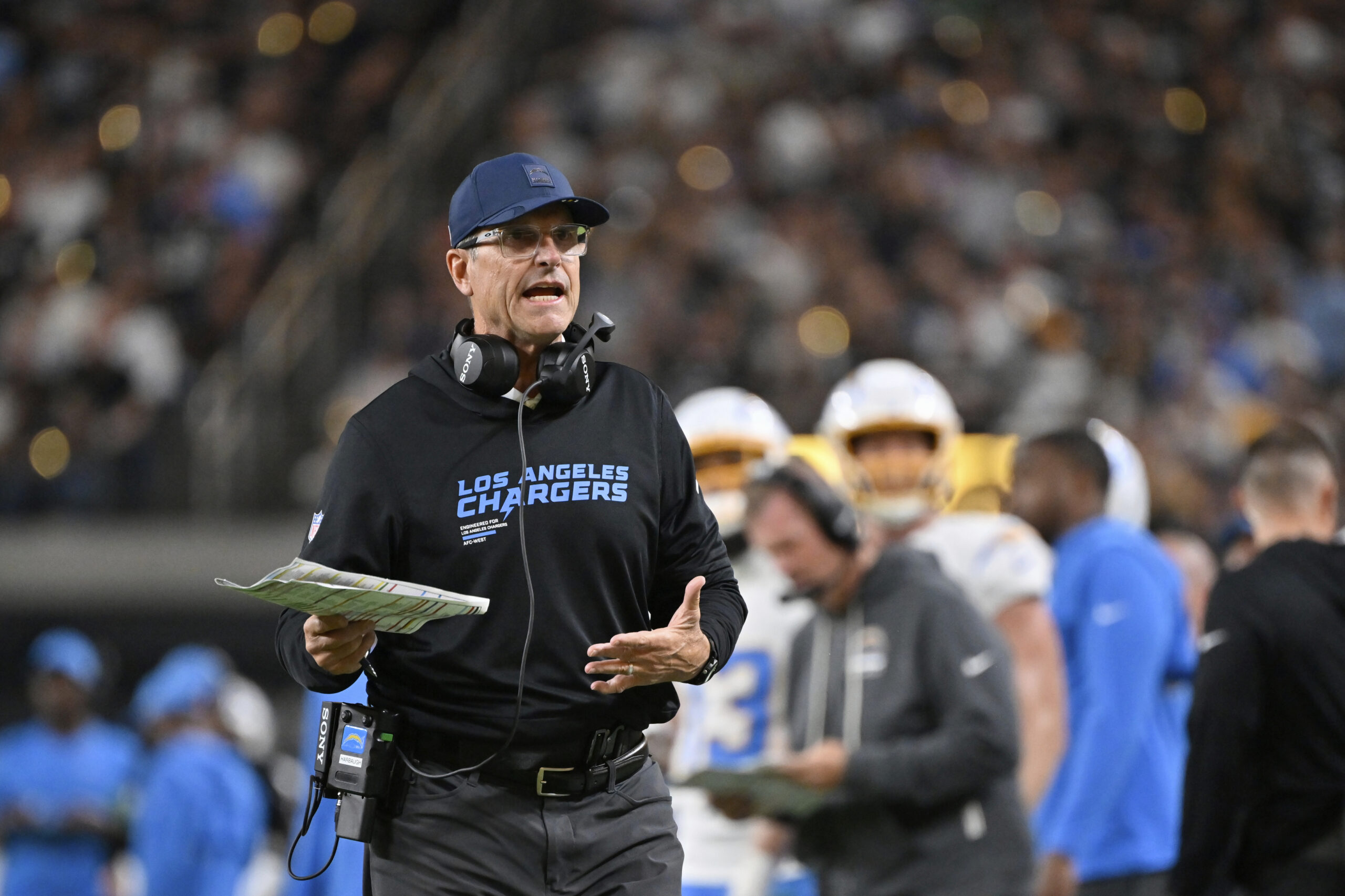 Chargers head coach Jim Harbaugh motions towards an official during...