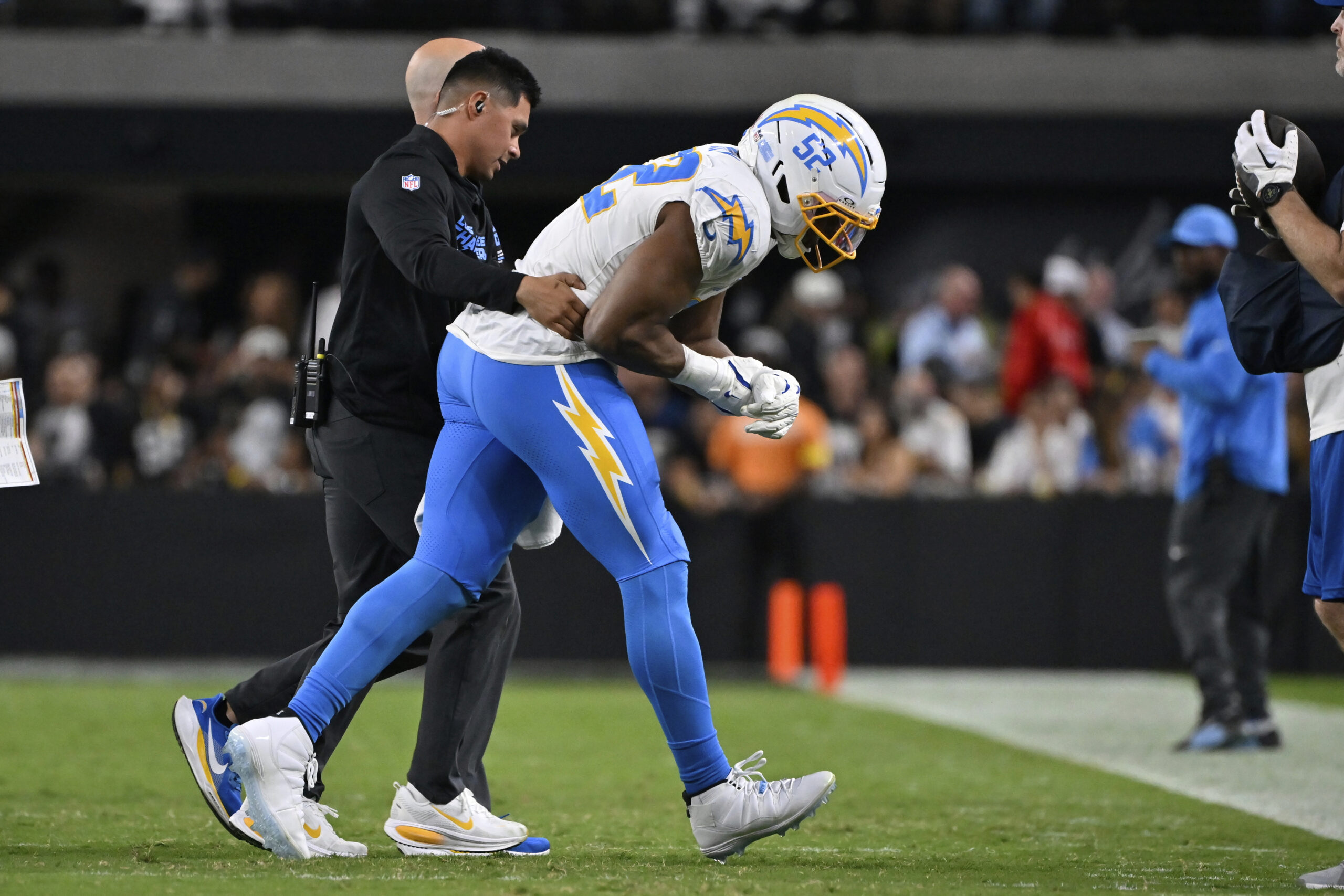 Chargers linebacker Khalil Mack is helped off the field during...
