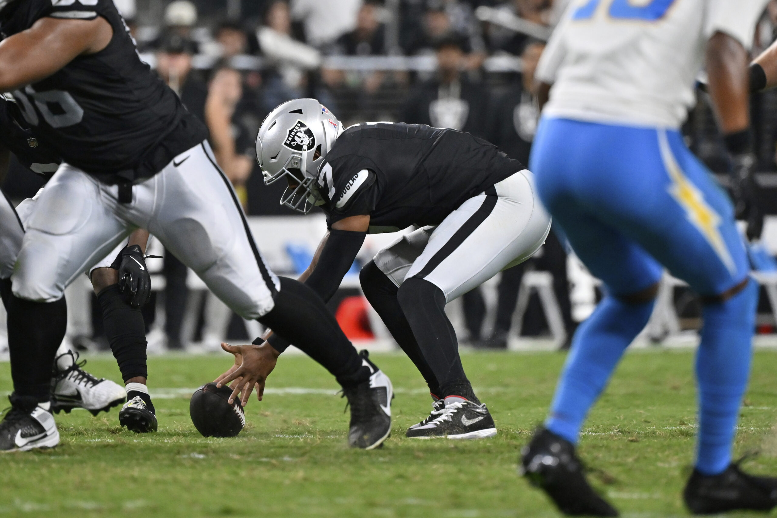 Las Vegas Raiders quarterback Geno Smith recovers a fumble against...