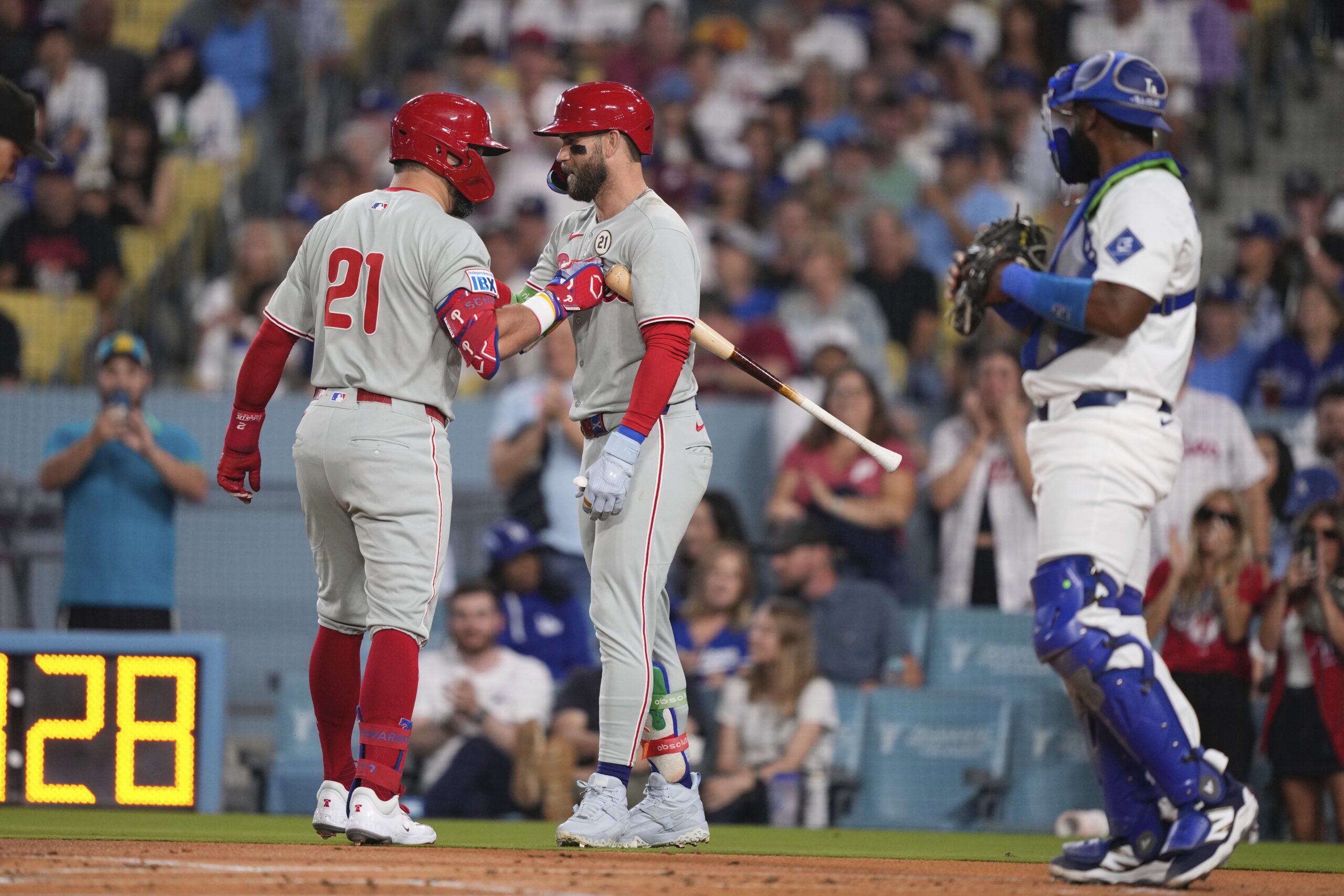 The Philadelphia Phillies’ Kyle Schwarber, left, is congratulated by teammate...