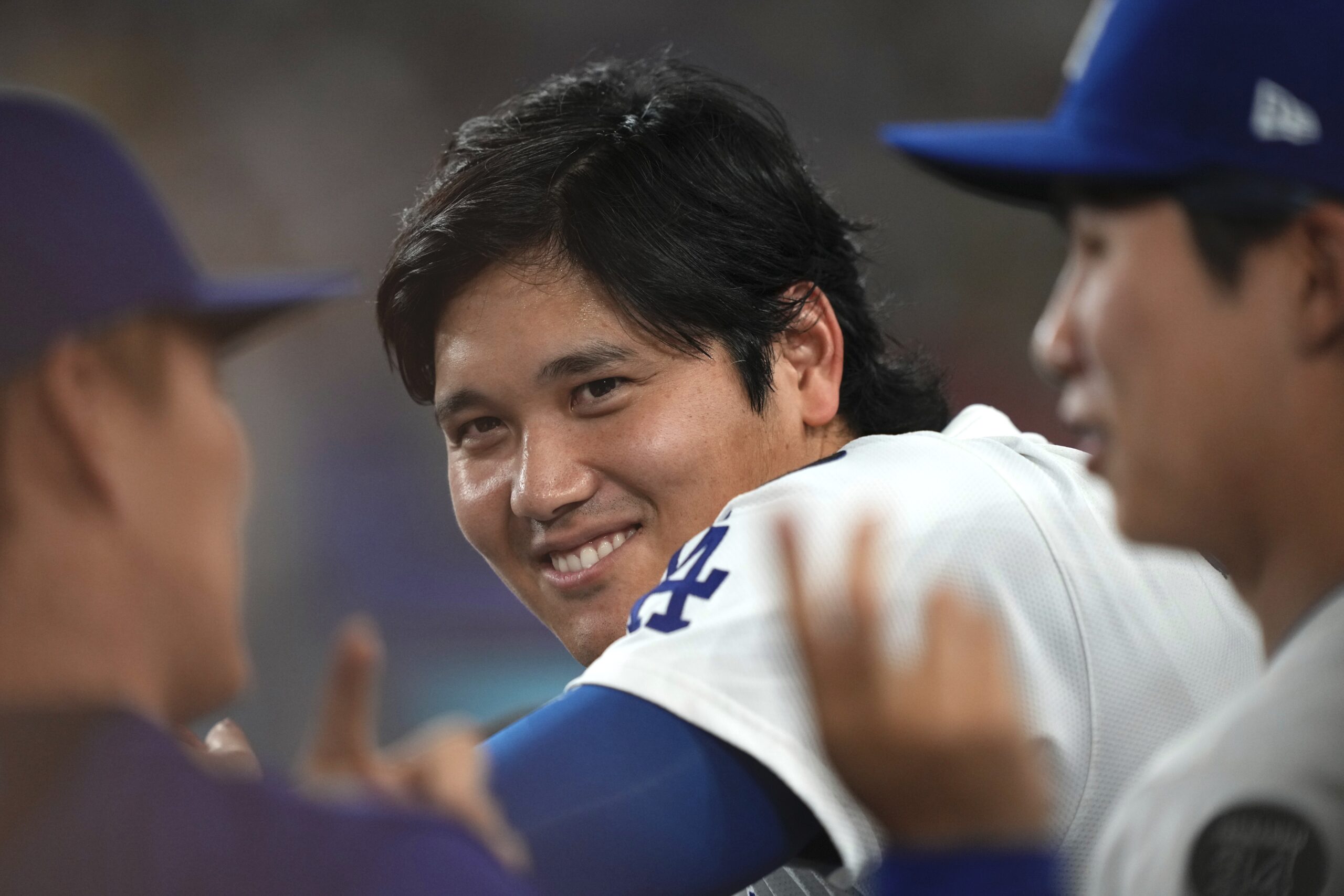 Dodgers star Shohei Ohtani, center, talks with teammates Yoshinobu Yamamoto,...