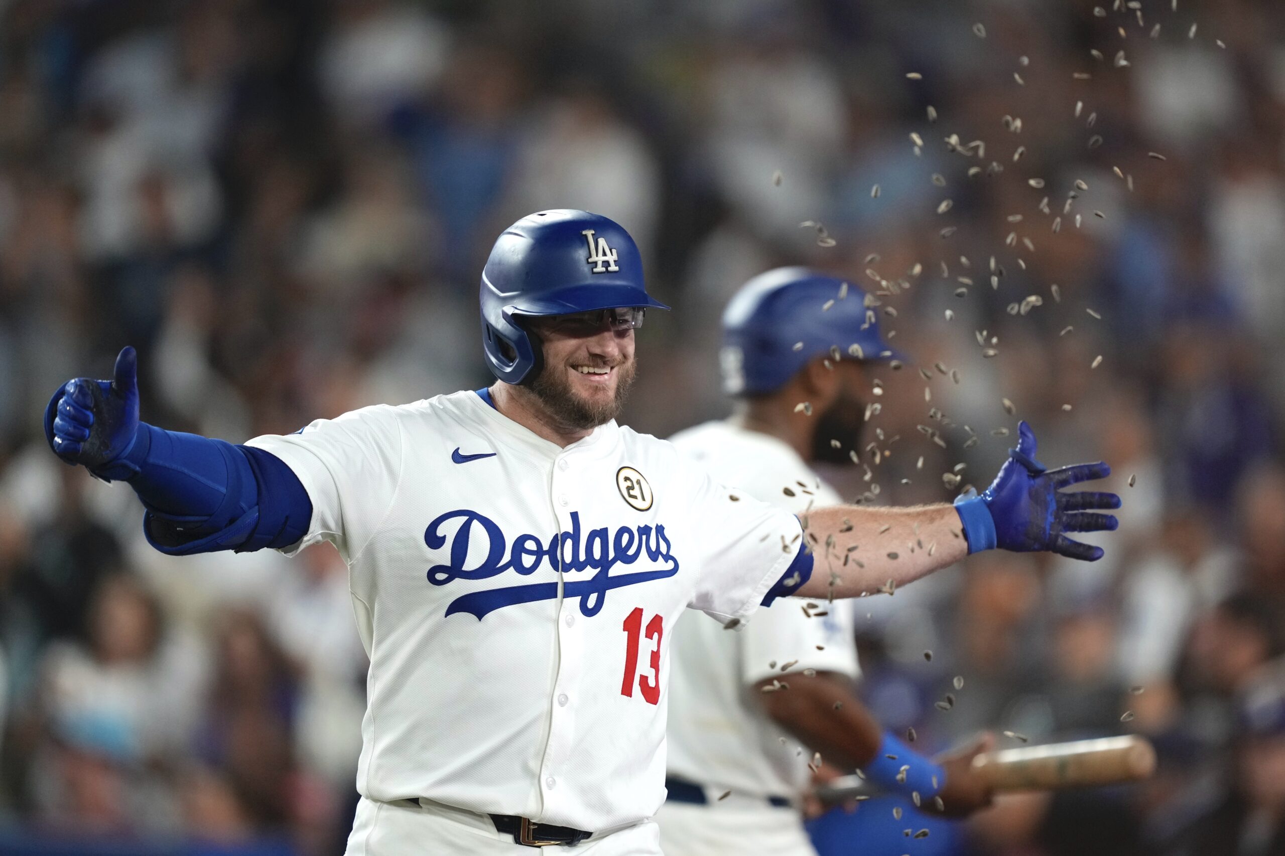 The Dodgers’ Max Muncy has seeds thrown at him as...