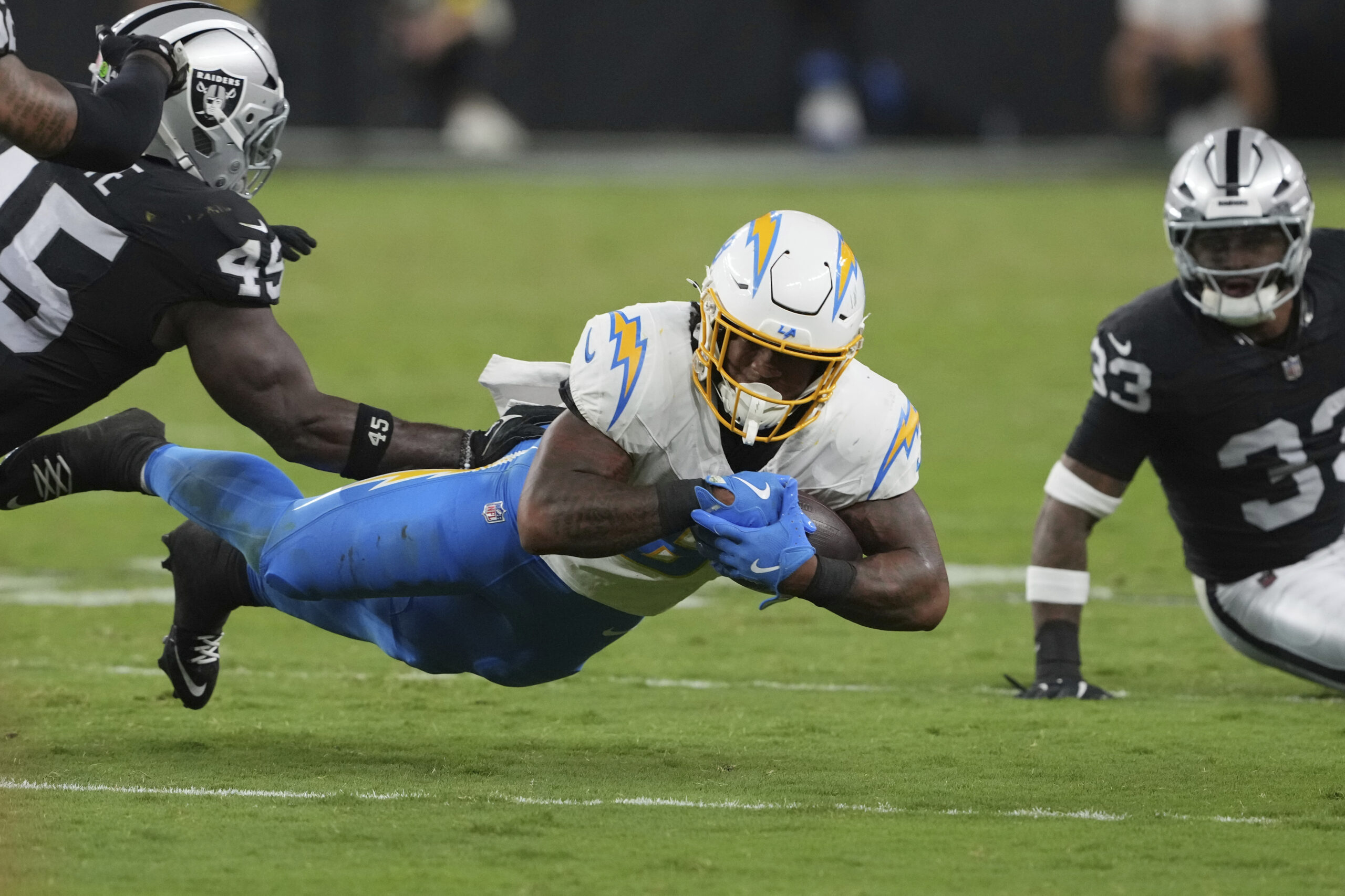 Chargers rookie running back Omarion Hampton dives for a first...