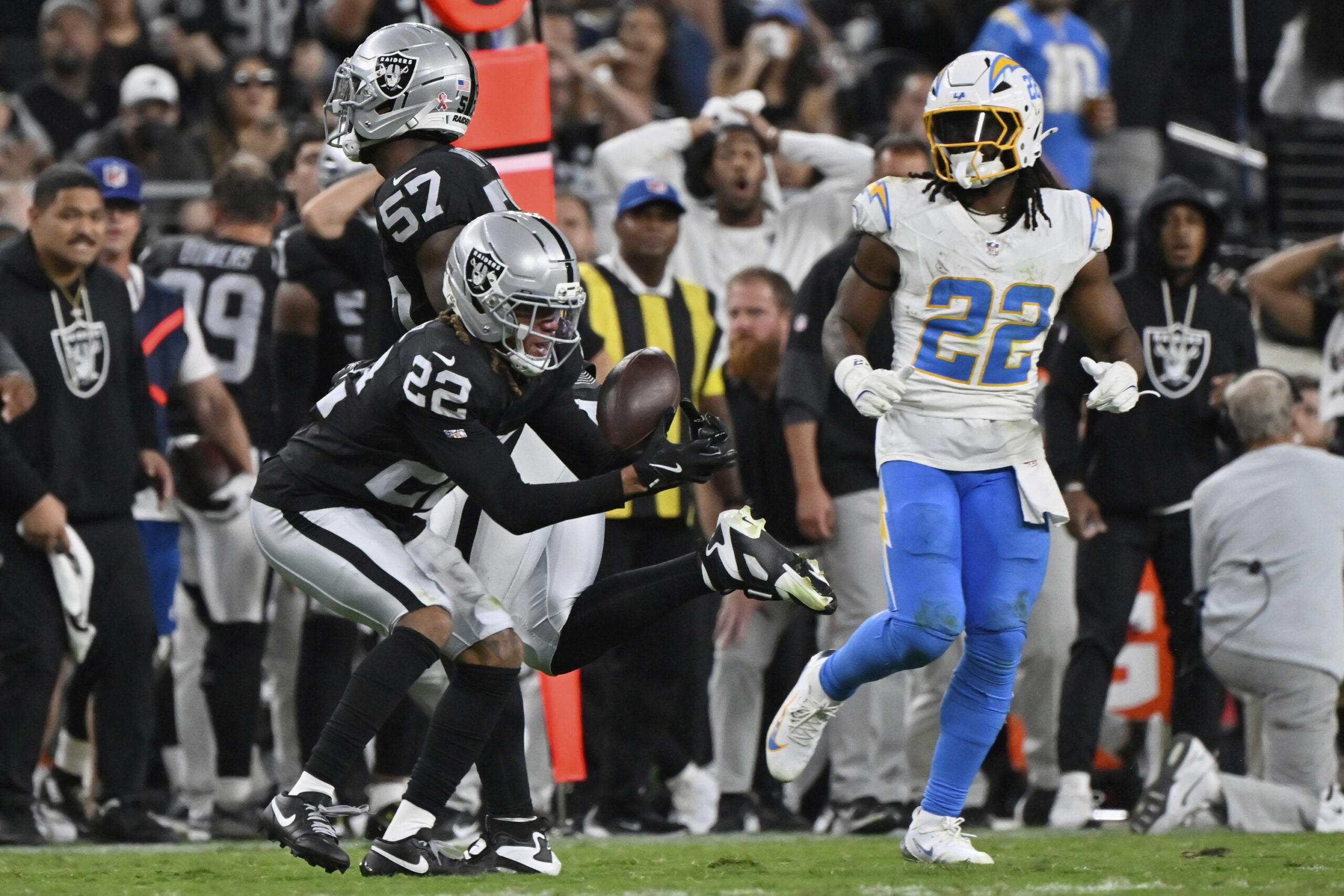 Las Vegas Raiders cornerback Eric Stokes, left, tries to intercept...
