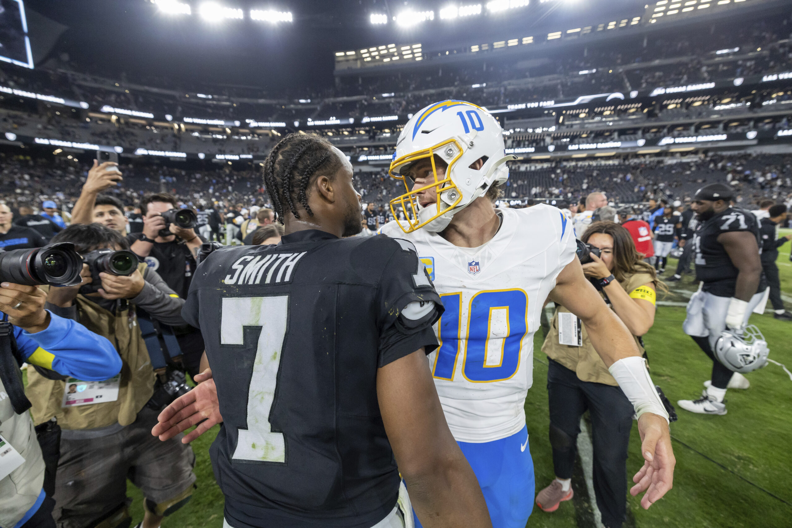 Chargers quarterback Justin Herbert and Las Vegas Raiders quarterback Geno...