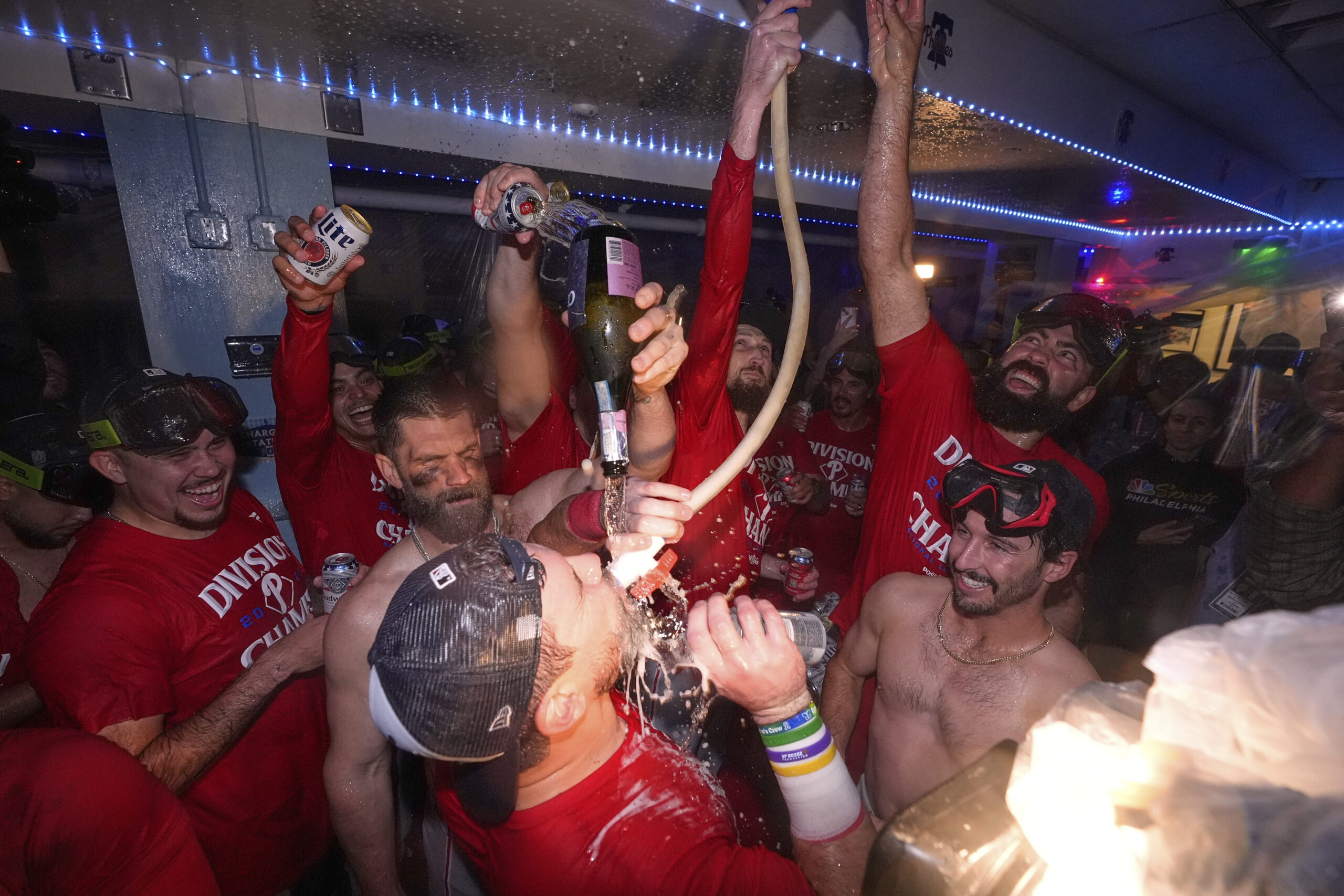 Members of the Philadelphia Phillies celebrate in the clubhouse after...
