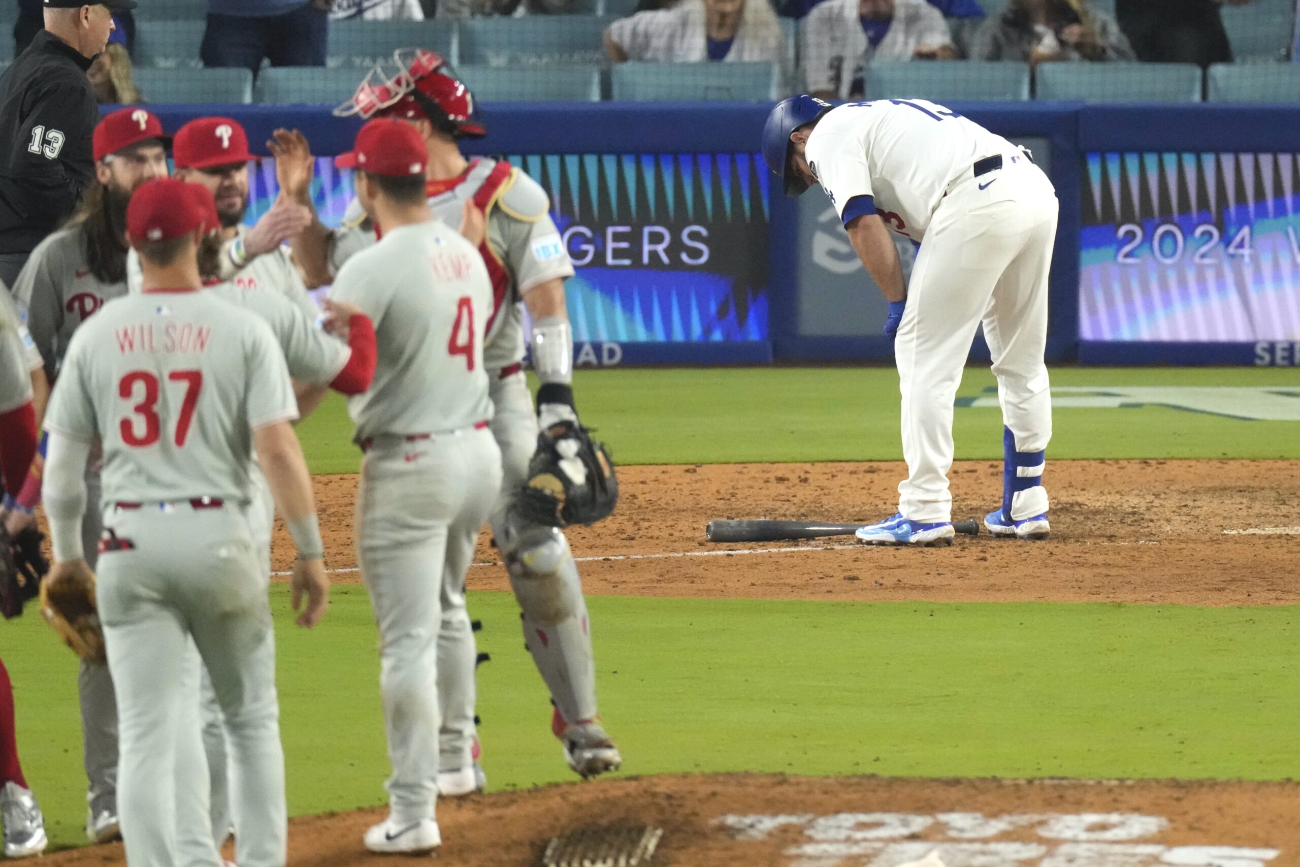 Phillies players celebrate on the field after a 6-5 victory...