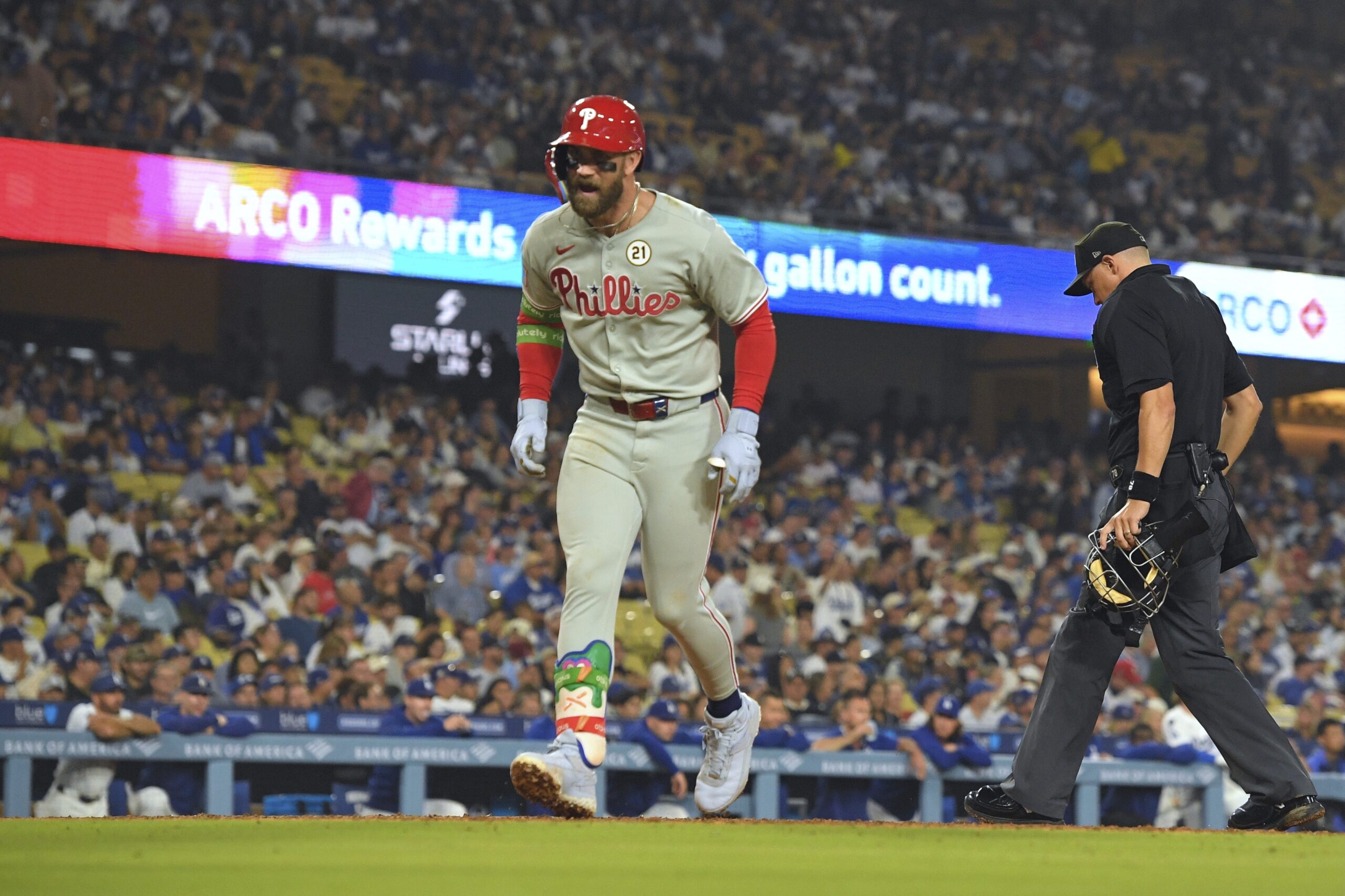 The Philadelphia Phillies’ Bryce Harper celebrates as he scores after...