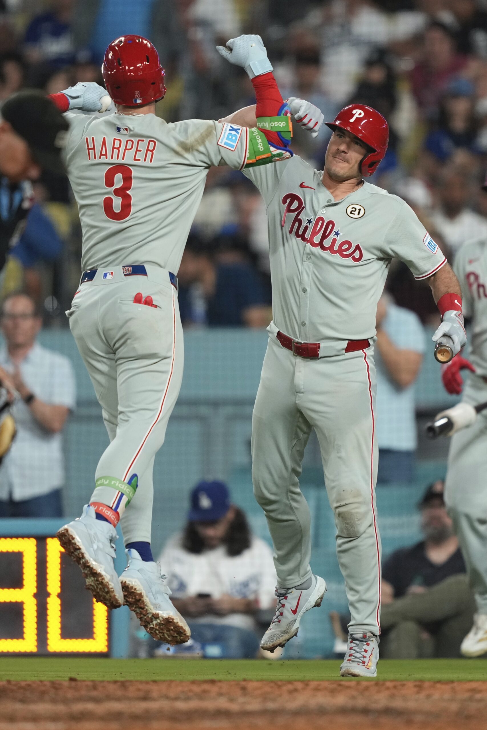 The Philadelphia Phillies’ Bryce Harper, left, celebrates with teammate J.T....