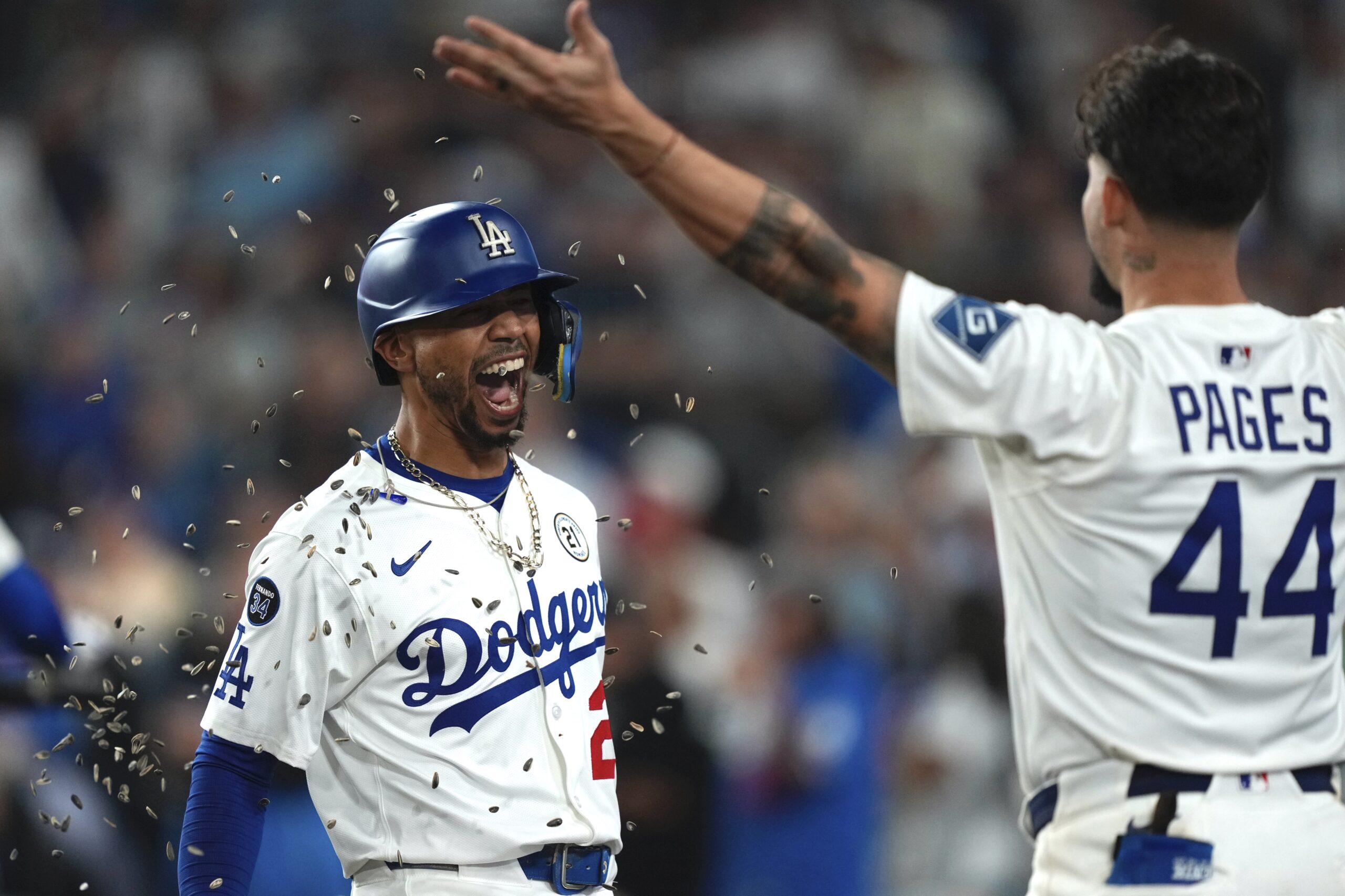 The Dodgers’ Mookie Betts has seeds thrown at him by...
