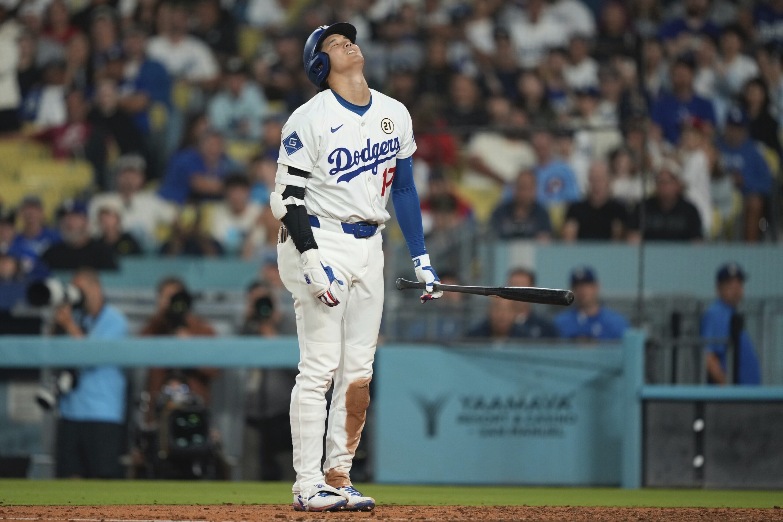 Dodgers star Shohei Ohtani reacts after striking out during the...