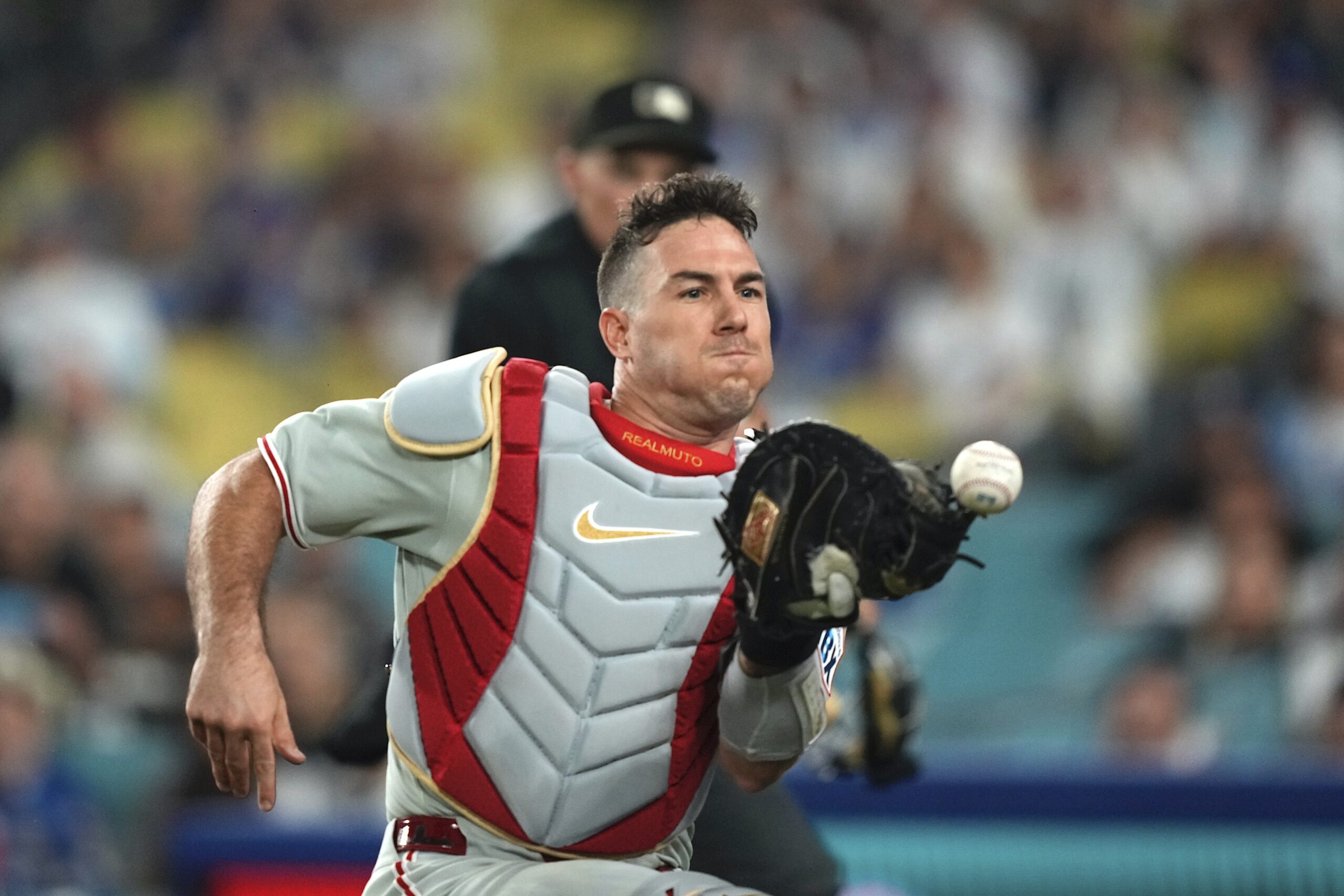 Philadelphia Phillies catcher J.T. Realmuto is unable to catch a...