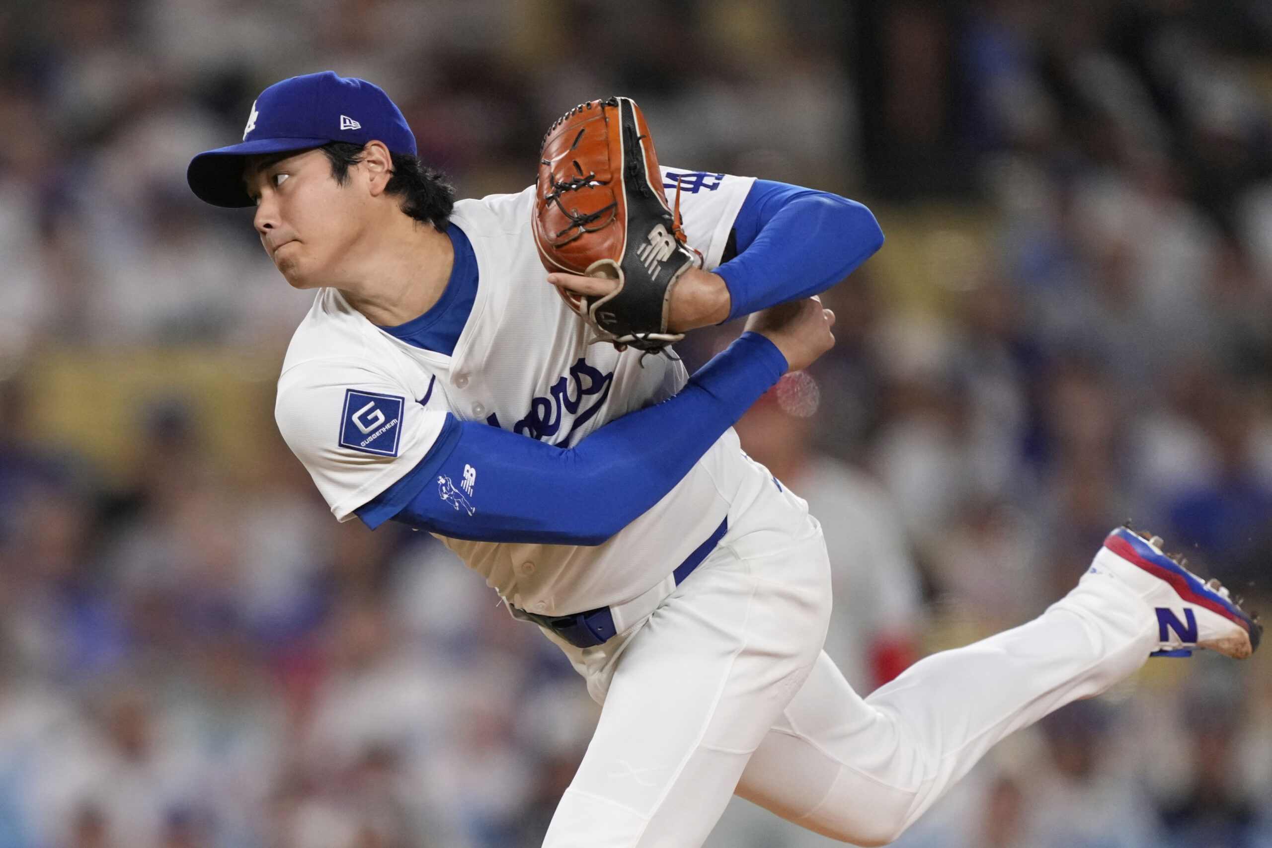Dodgers starting pitcher Shohei Ohtani throws to the plate during...