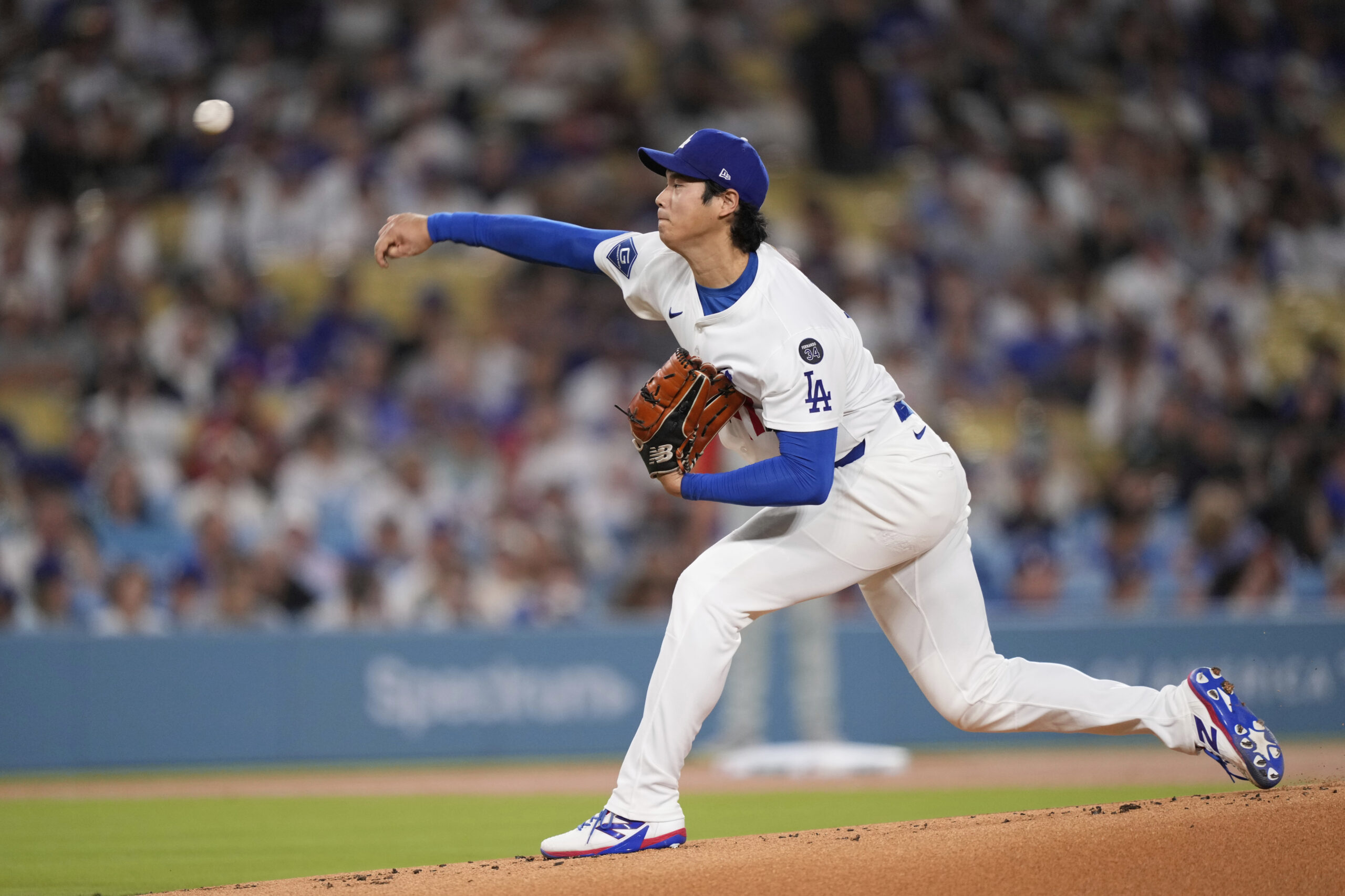 Dodgers starting pitcher Shohei Ohtani throws to the plate during...