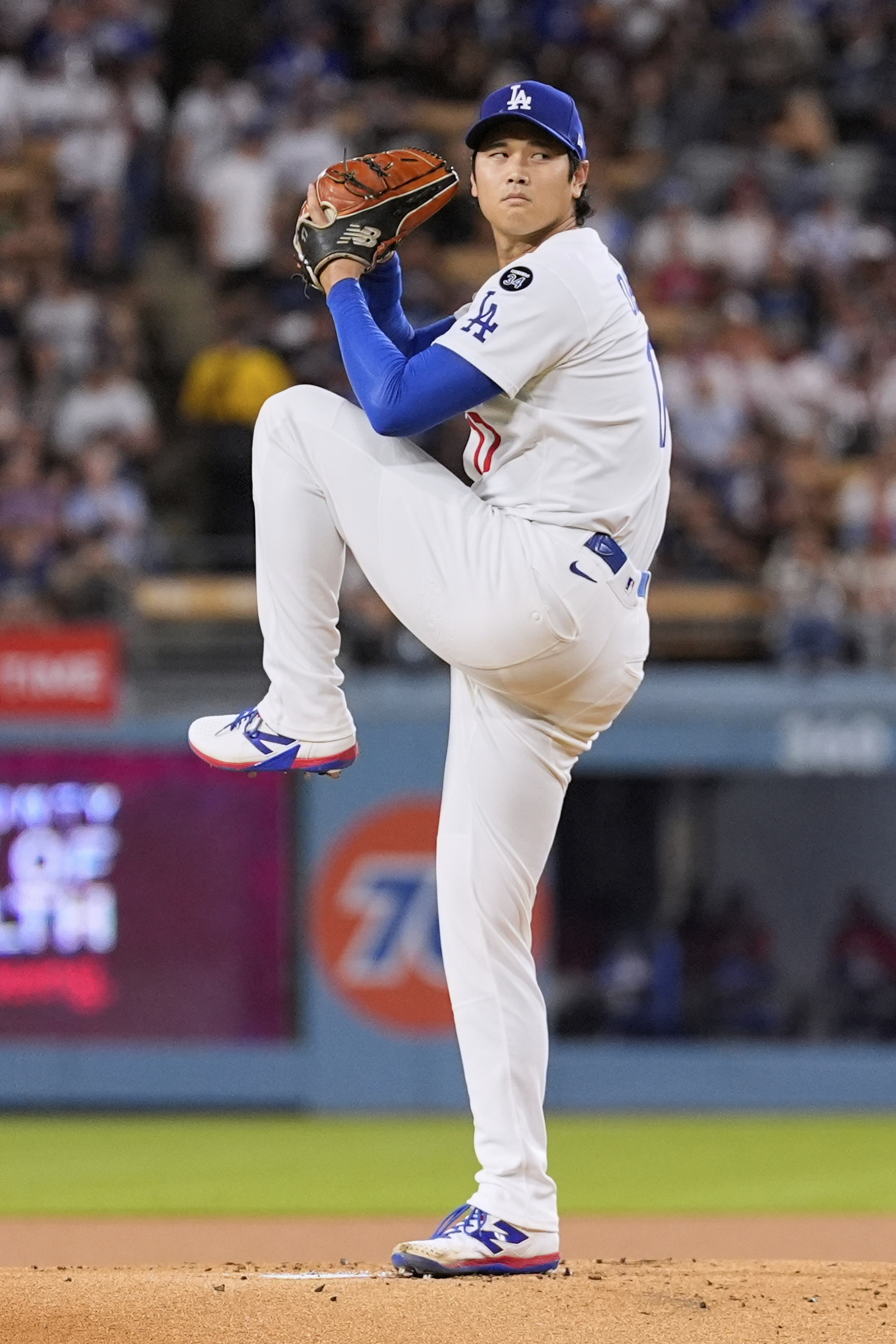 Dodgers starting pitcher Shohei Ohtani throws to the plate during...