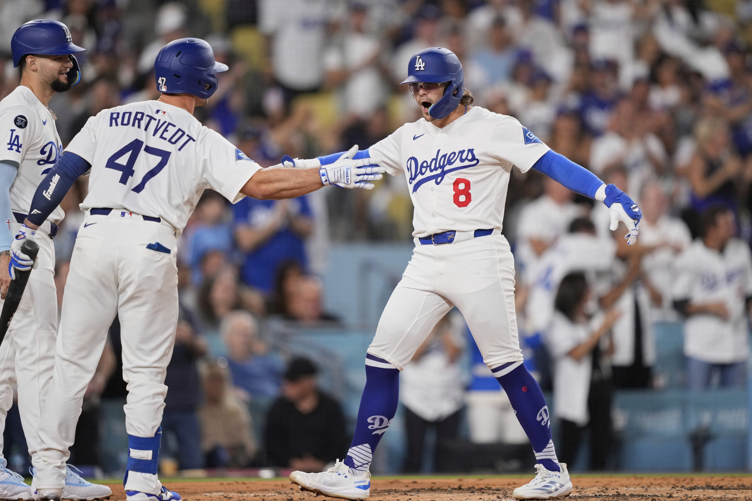 The Dodgers’ Kiké Hernandez (8) celebrates with teammates Ben Rortvedt...