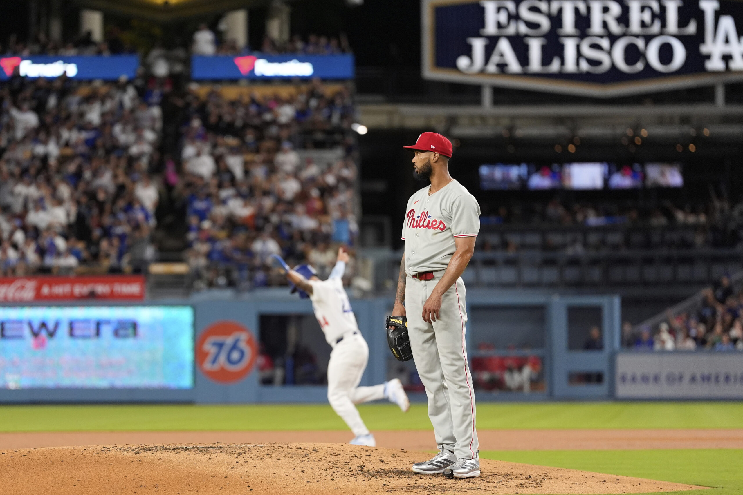 Philadelphia Phillies starting pitcher Cristopher Sanchez, right, looks on as...