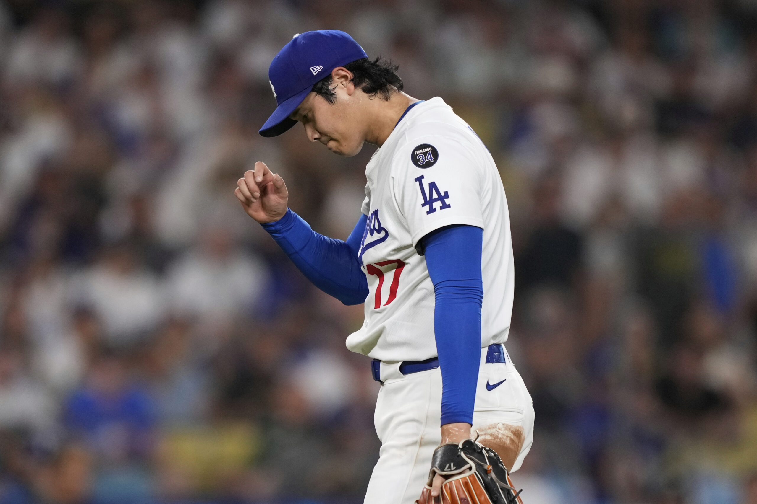 Dodgers starting pitcher Shohei Ohtani pumps his fist during the...
