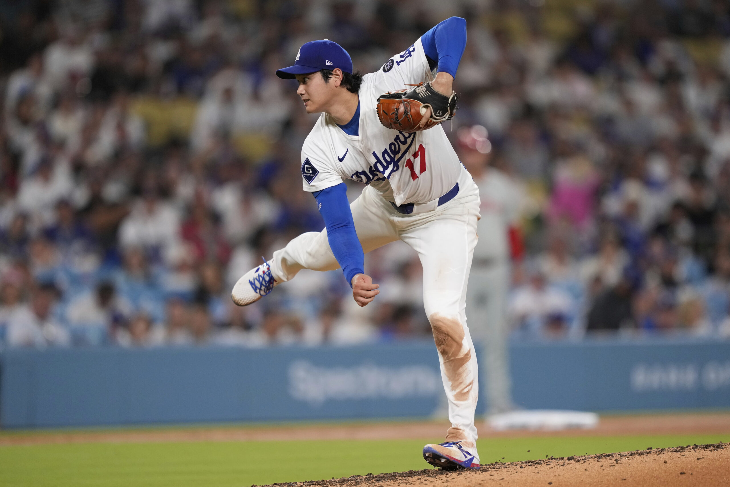 Dodgers starting pitcher Shohei Ohtani throws to the plate during...