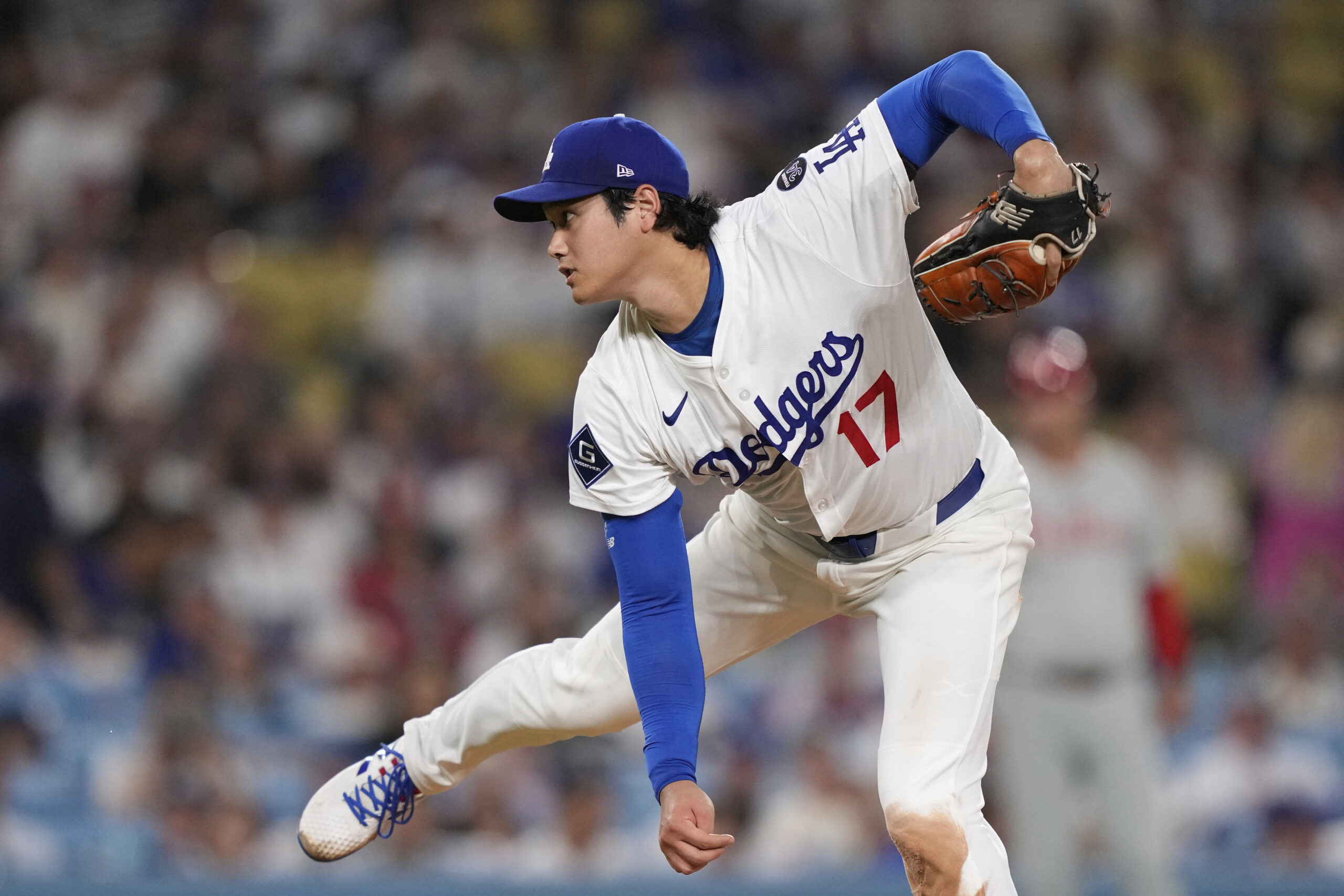 Dodgers starting pitcher Shohei Ohtani throws to the plate during...