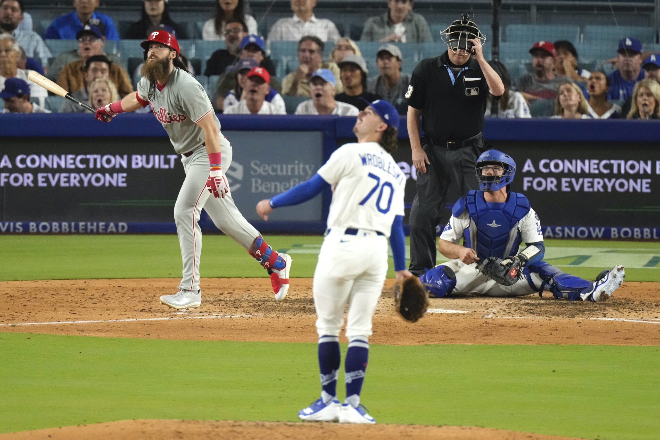 The Philadelphia Phillies’ Brandon Marsh, left, heads to first for...