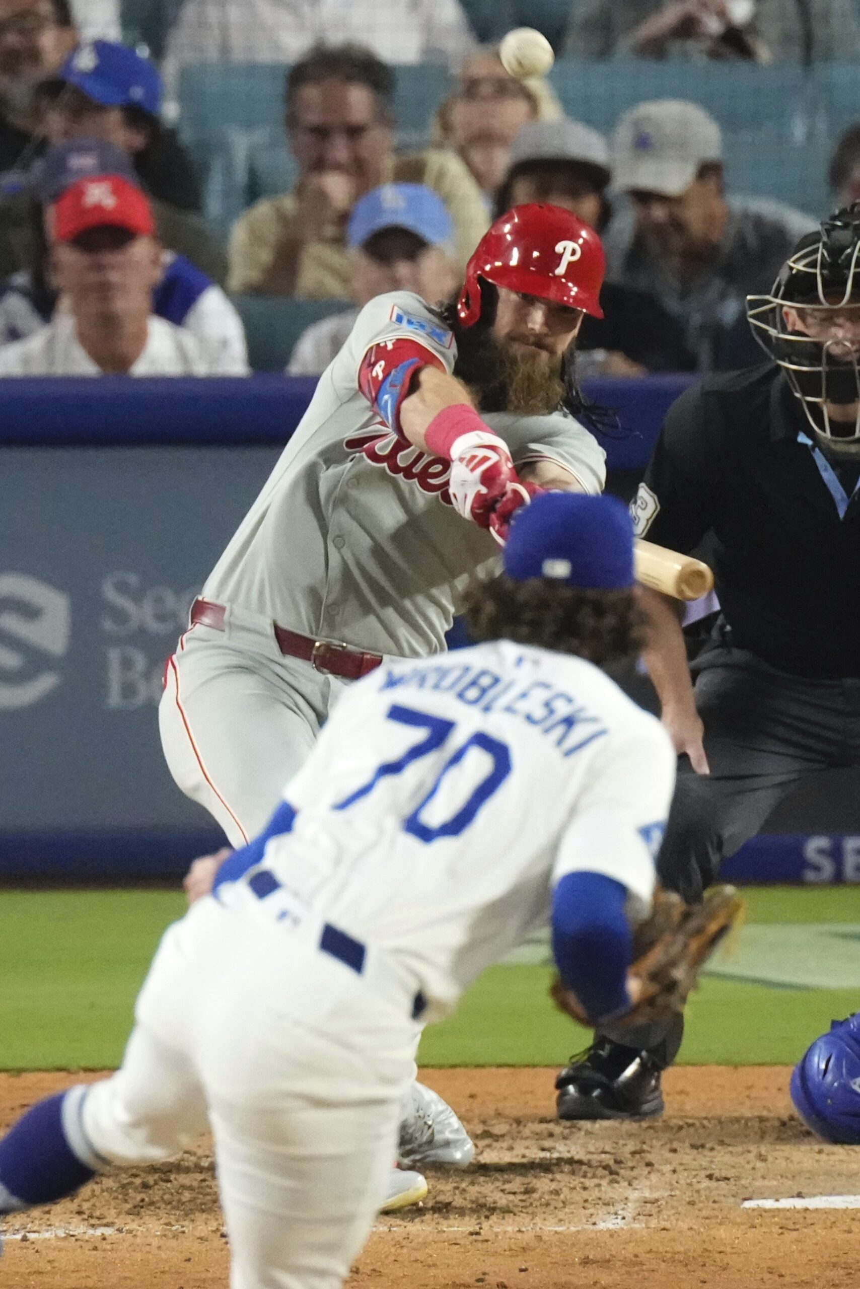 The Philadelphia Phillies’ Brandon Marsh, left, heads to first for...