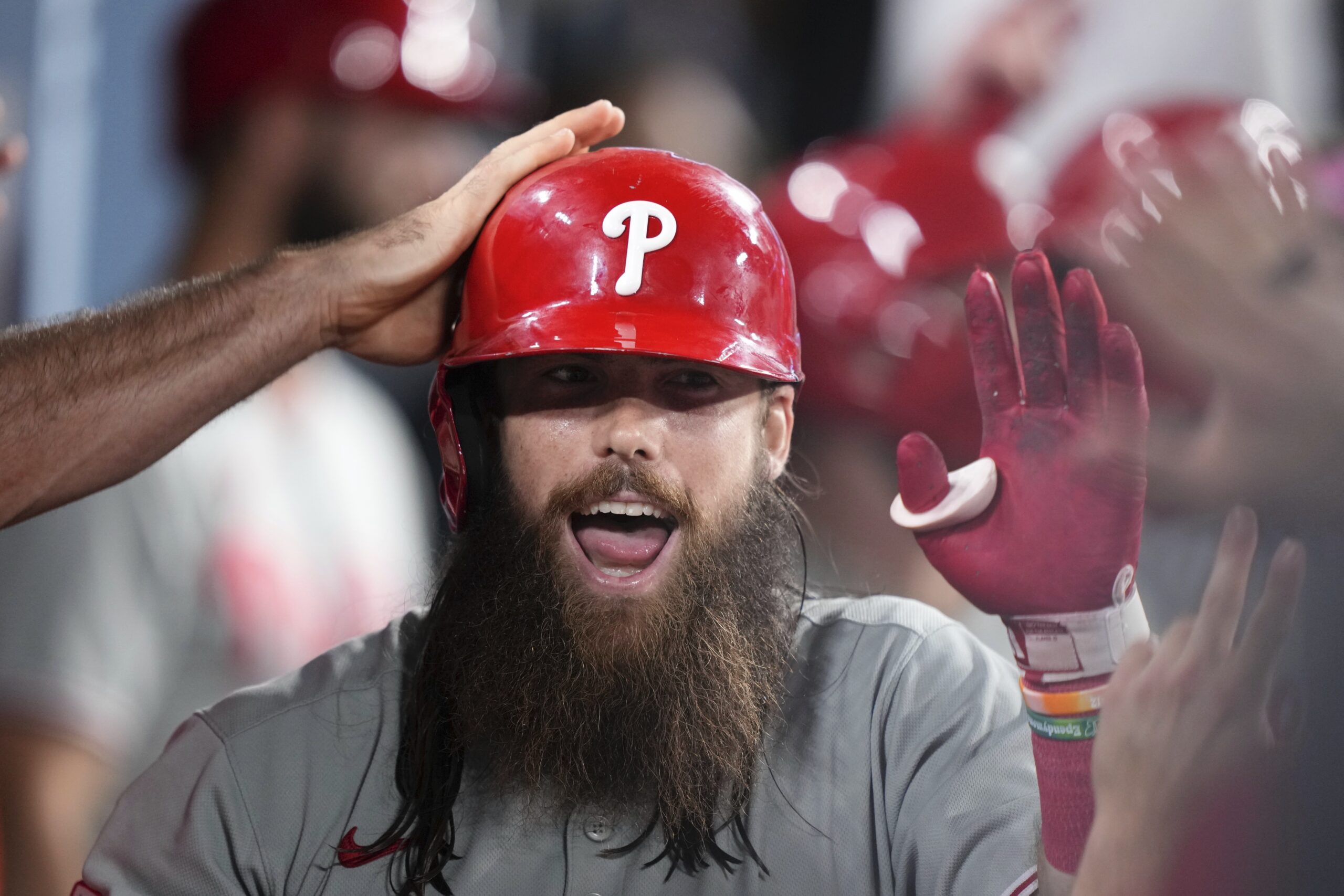 The Philadelphia Phillies’ Brandon Marsh is congratulated by teammates in...