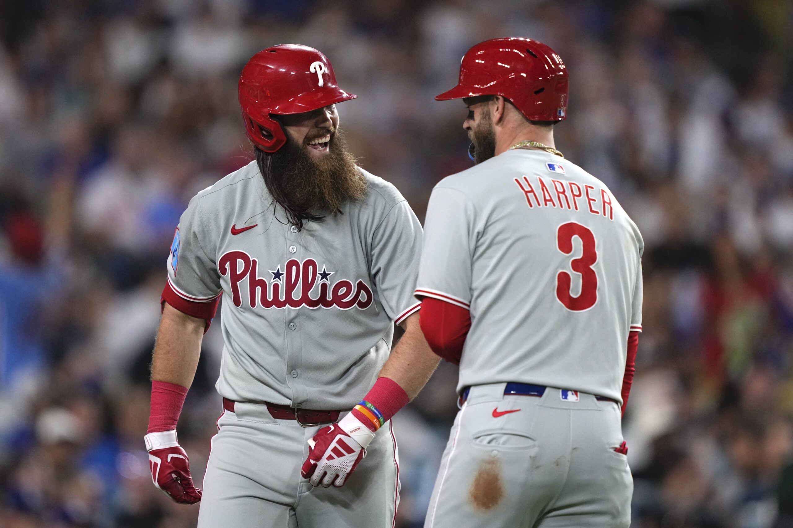 The Philadelphia Phillies’ Brandon Marsh, left, is congratulated by Bryce...