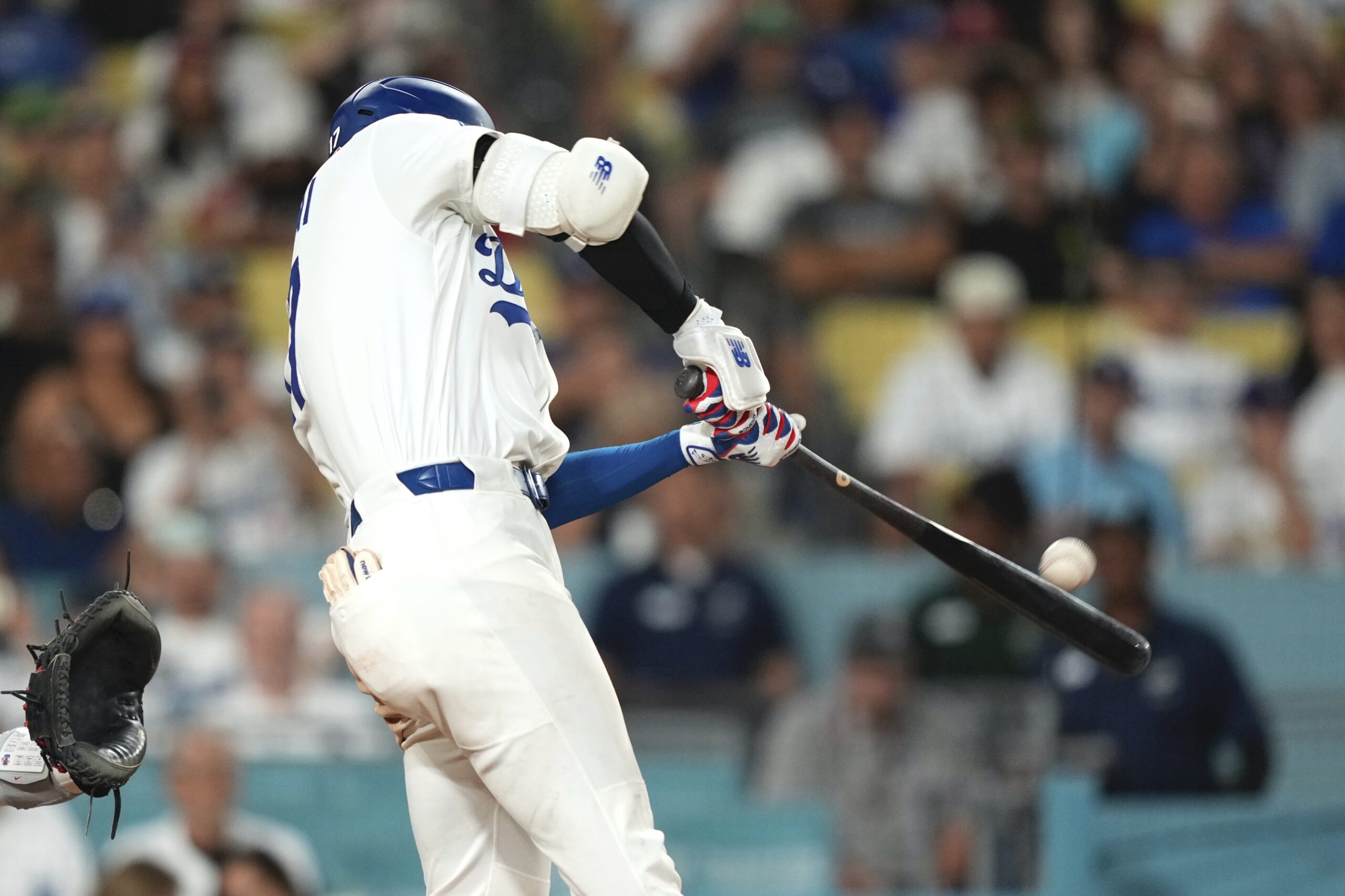 Dodgers star Shohei Ohtani watches the flight of his solo...