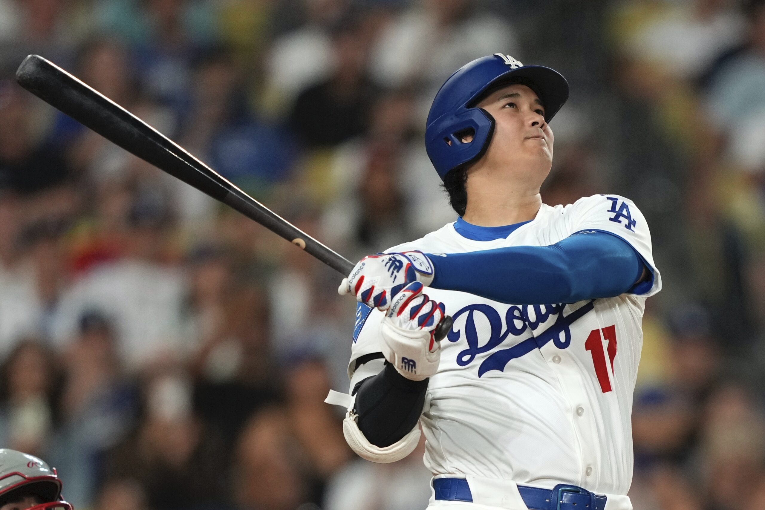 Dodgers star Shohei Ohtani watches the flight of his solo...