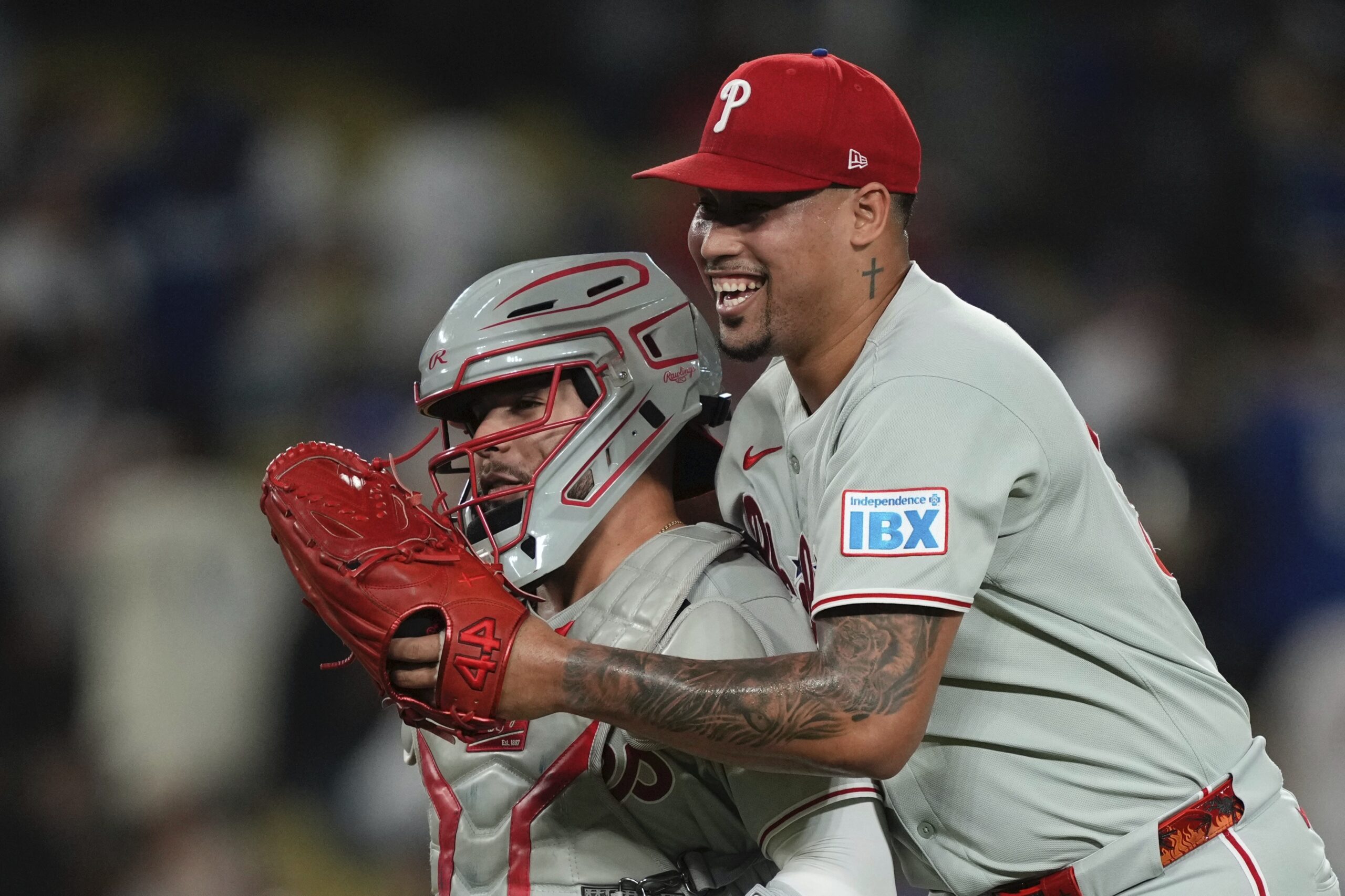 Philadelphia Phillies relief pitcher Jhoan Duran, right, celebrates with catcher...