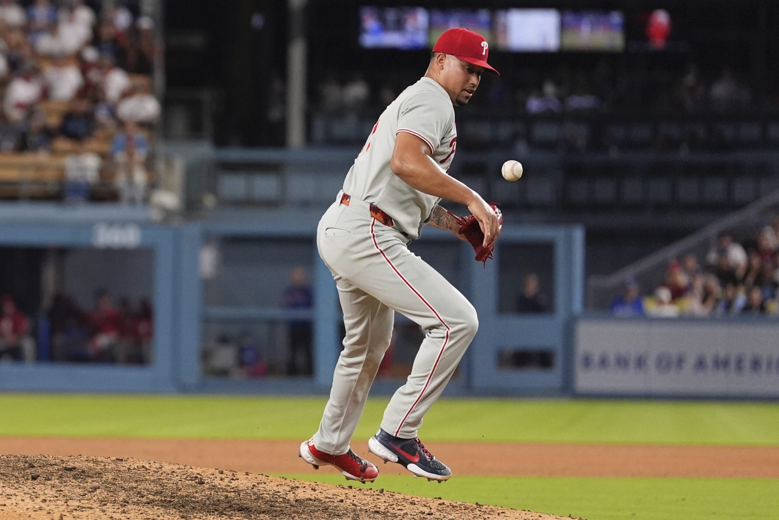 Philadelphia Phillies relief pitcher Jhoan Duran deflects a ball hit...