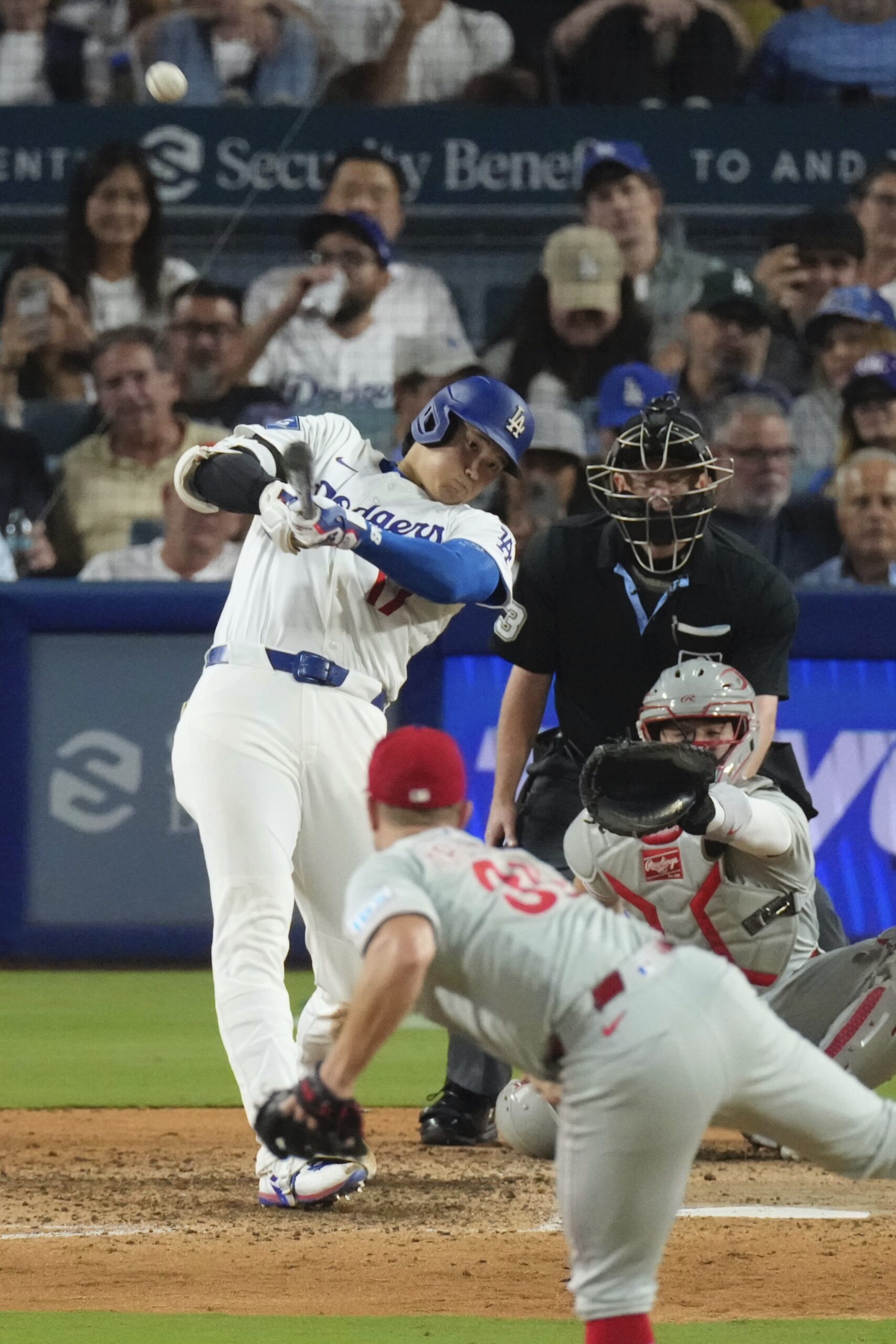 Dodgers star Shohei Ohtani, left, hits a solo home run...