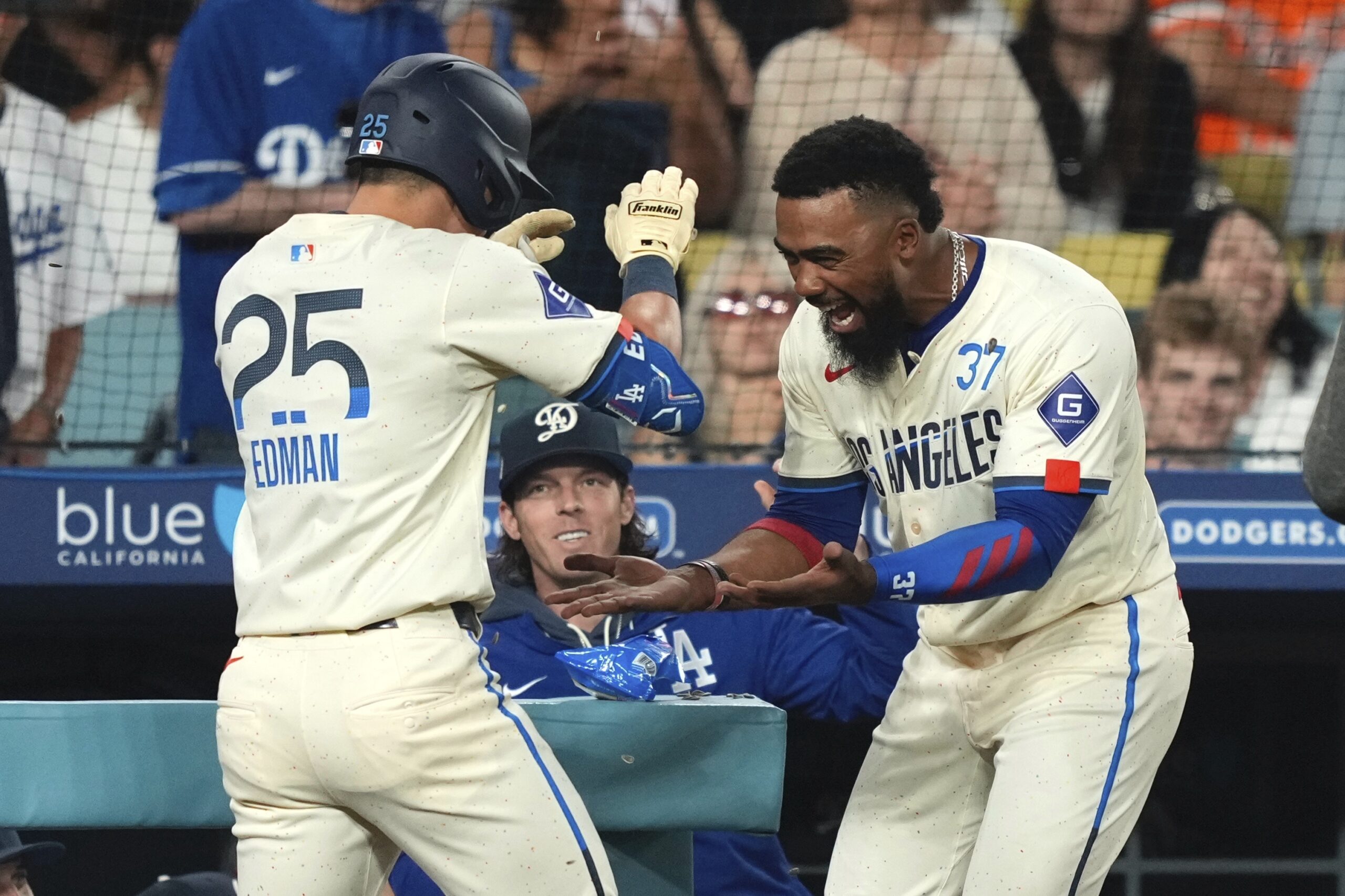 Dodgers’ Tommy Edman is congratulated by Teoscar Hernández after hitting...