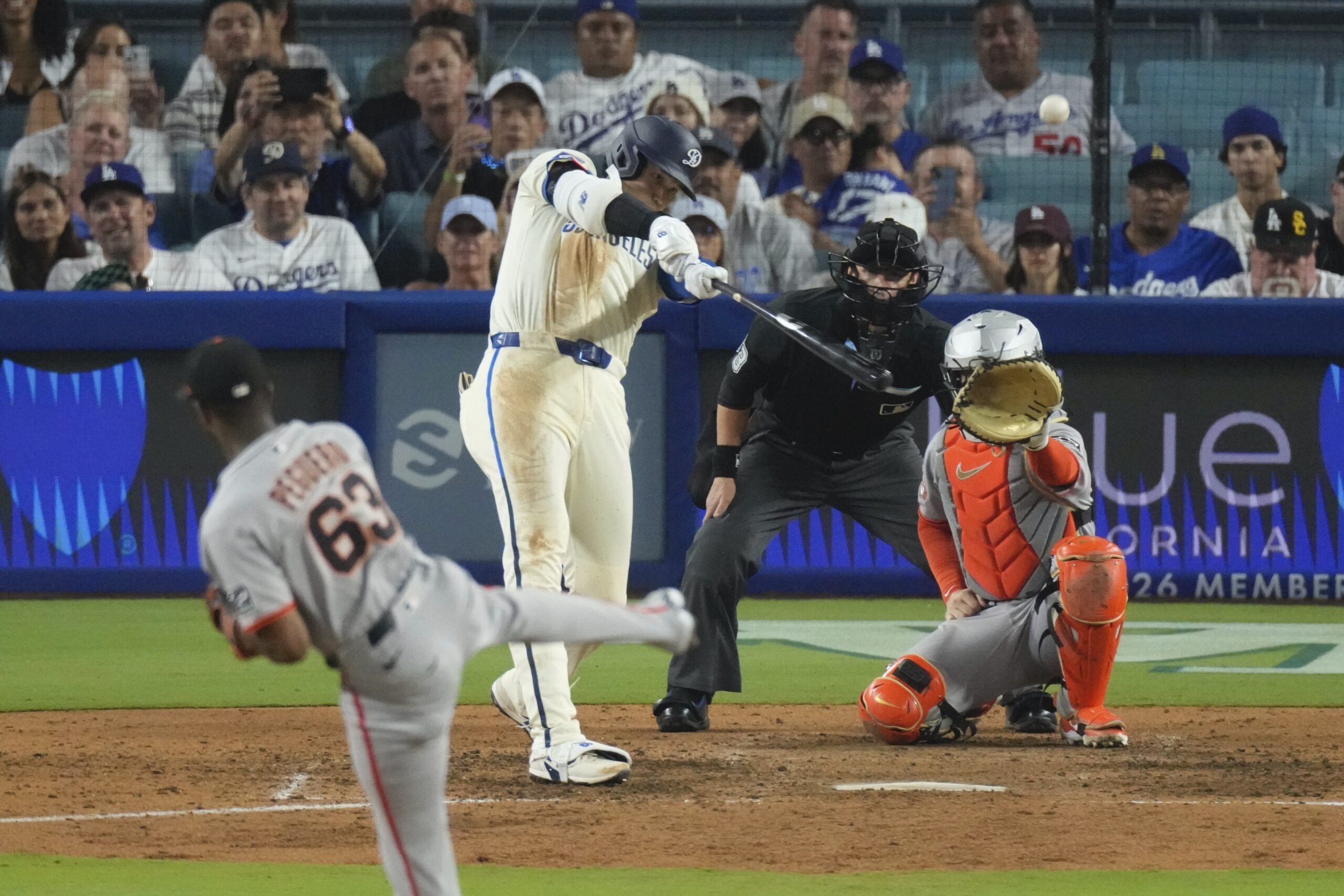 Dodgers’ Shohei Ohtani, second from left, heads hits a solo...