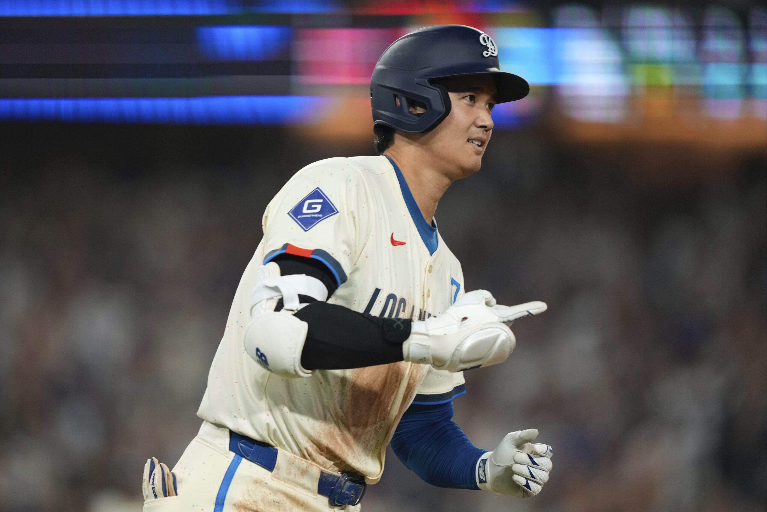 Dodgers’ Shohei Ohtani heads to first after hitting a solo...