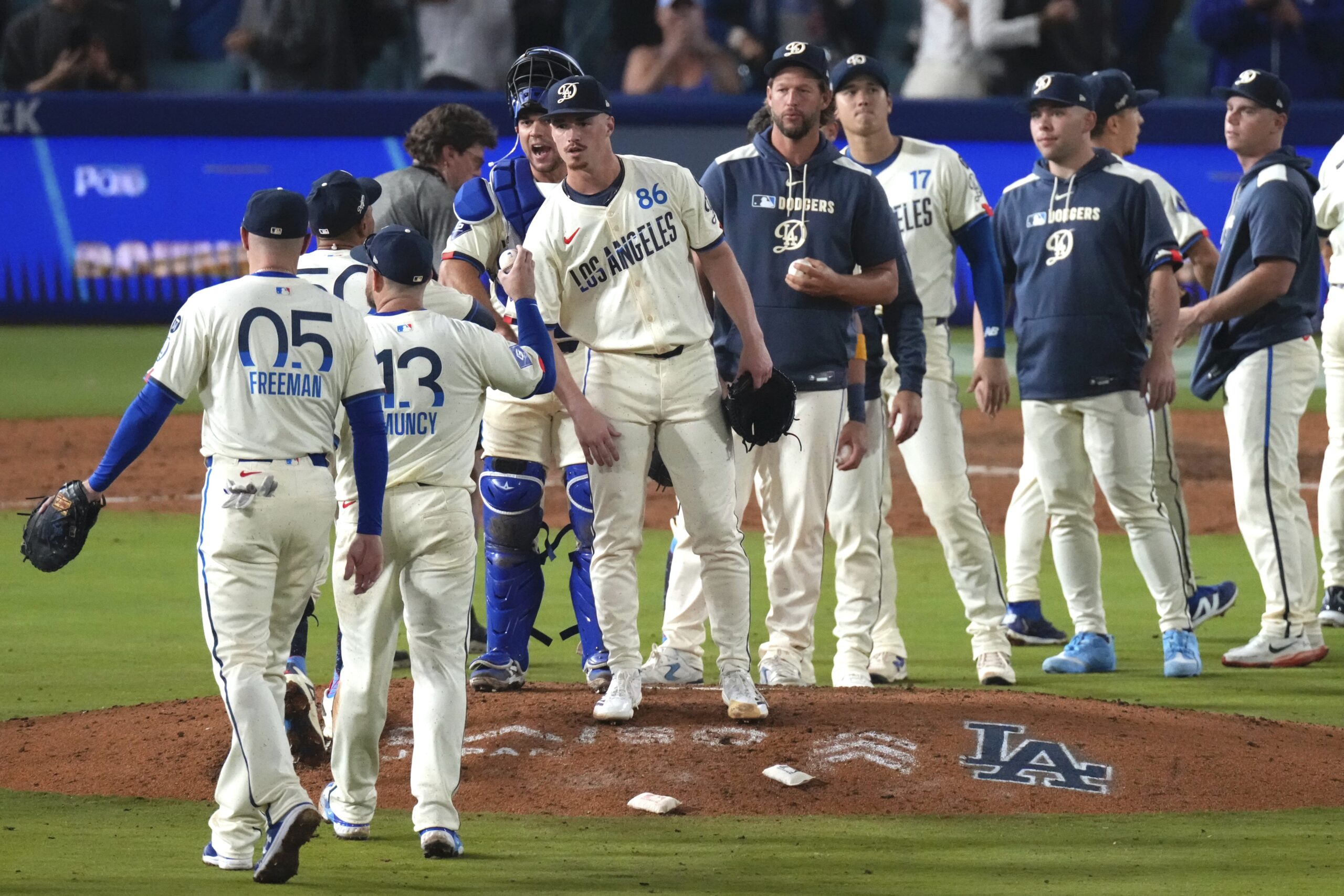 Members of the Dodgers congratulate each other after they defeated...