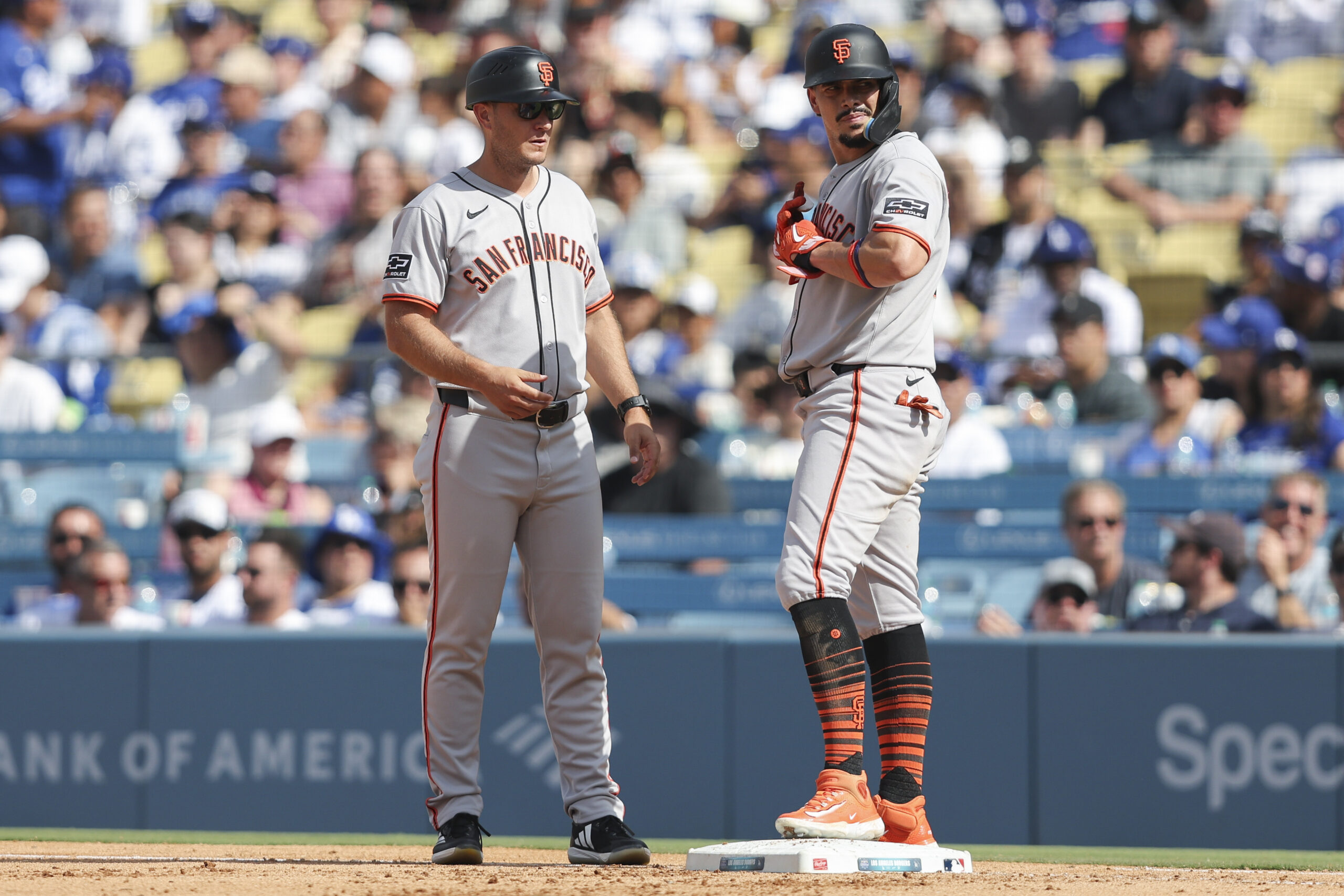 San Francisco Giants’ Willy Adames, right, looks on after being...