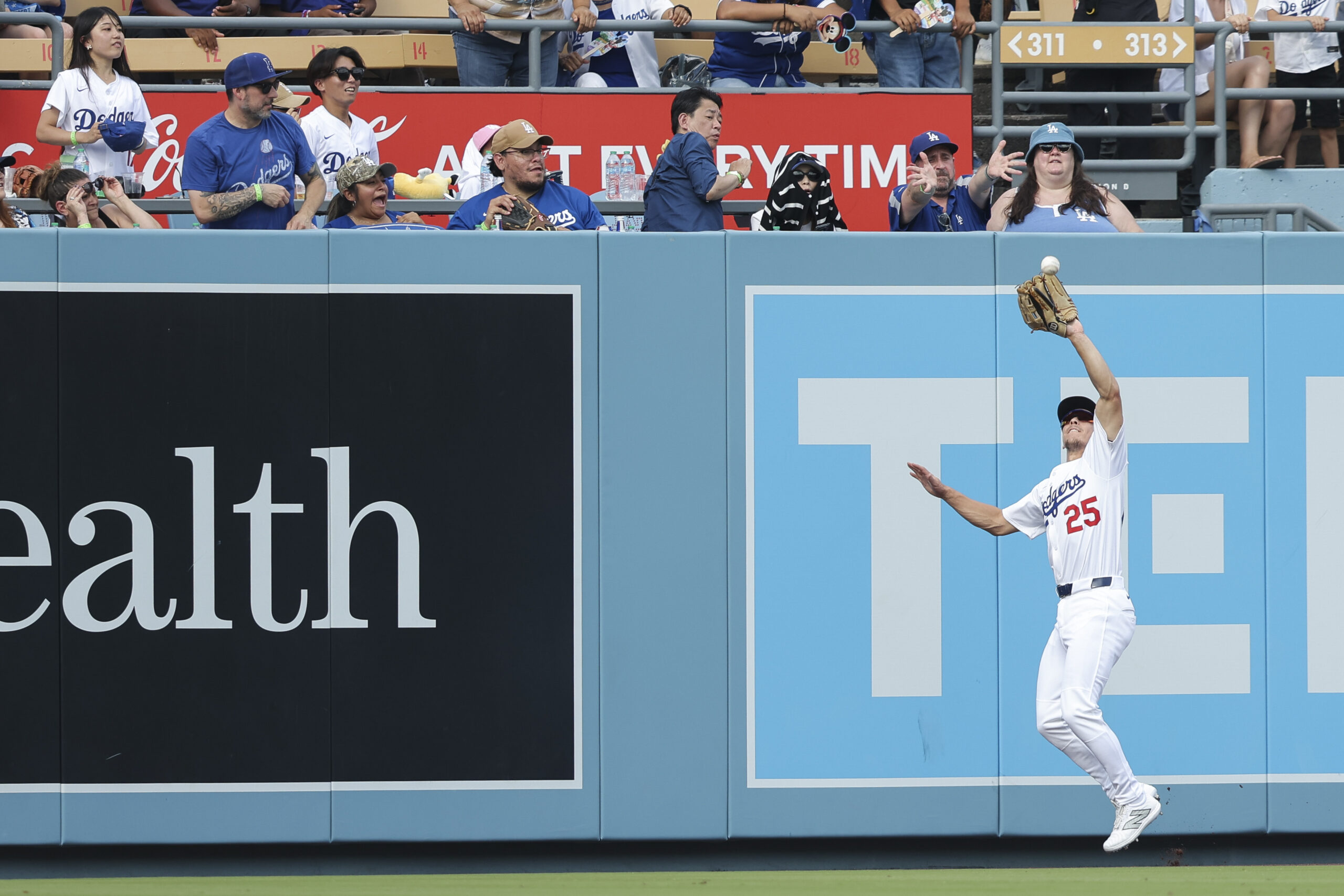 Los Angeles Dodgers left fielder Tommy Edman makes a catch...