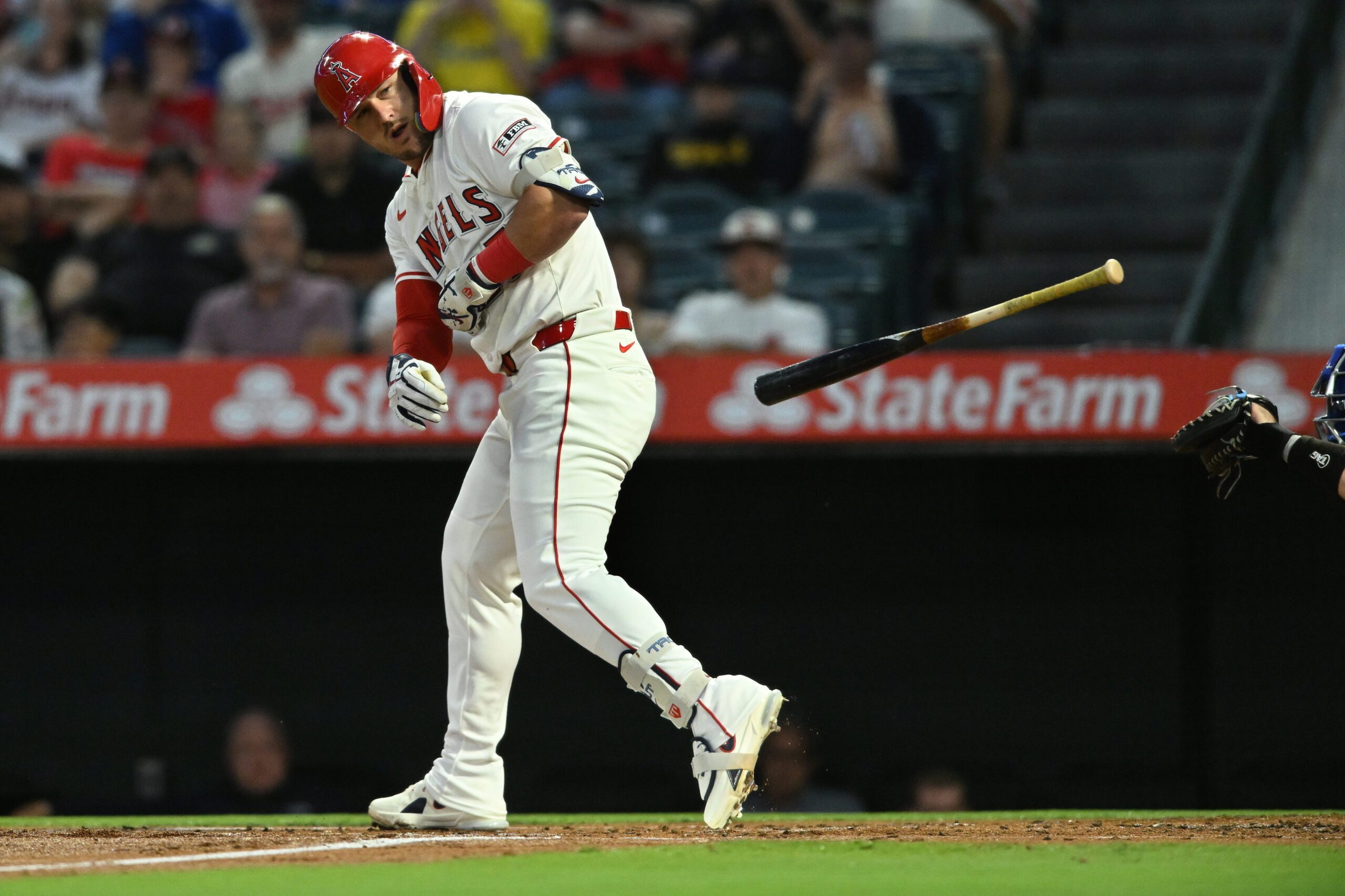 Angels star Mike Trout throws his bat as he begins...