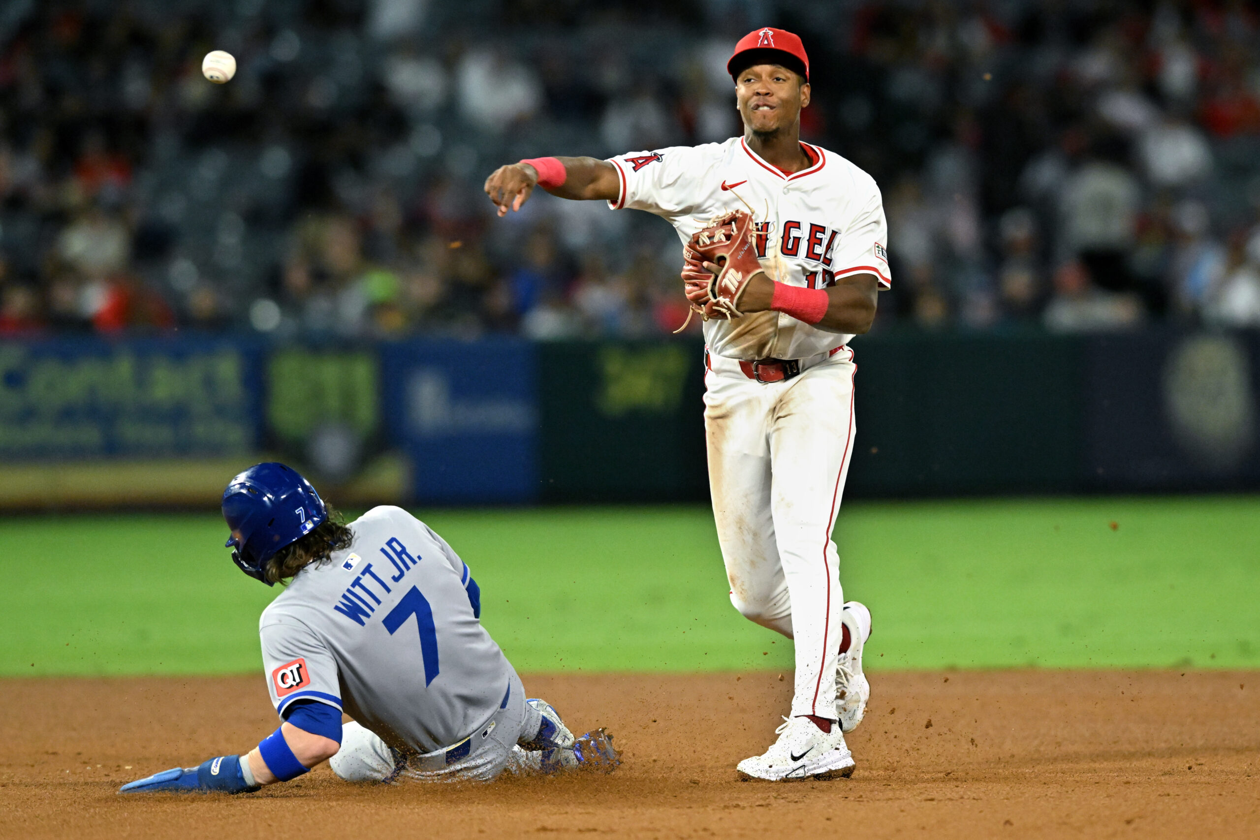 Angels shortstop Denzer Guzman throws to first base after forcing...