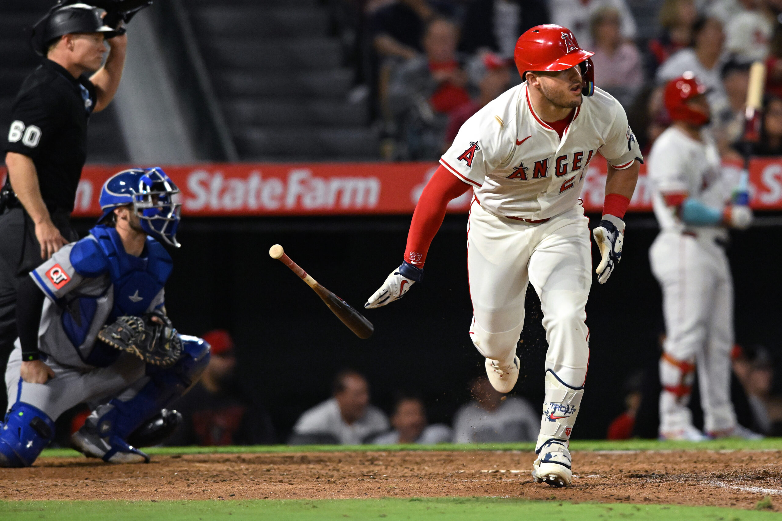 Angels star Mike Trout drops his bat as he watches...