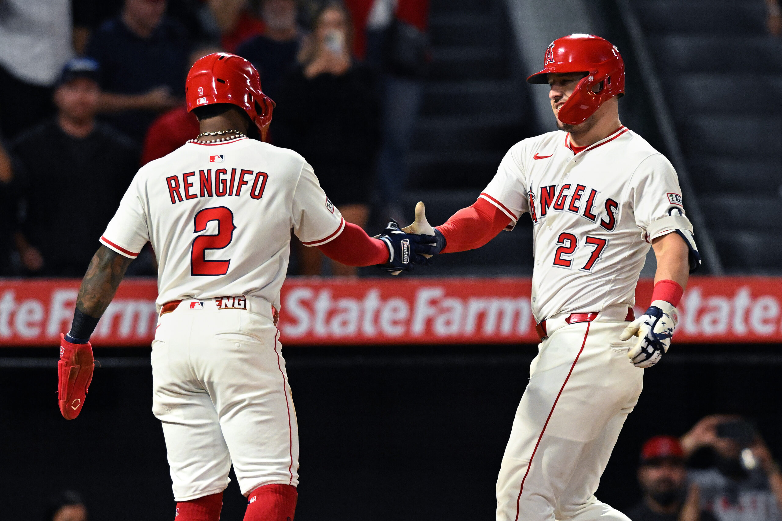 Angels star Mike Trout, right, celebrates with teammate Luis Rengifo...