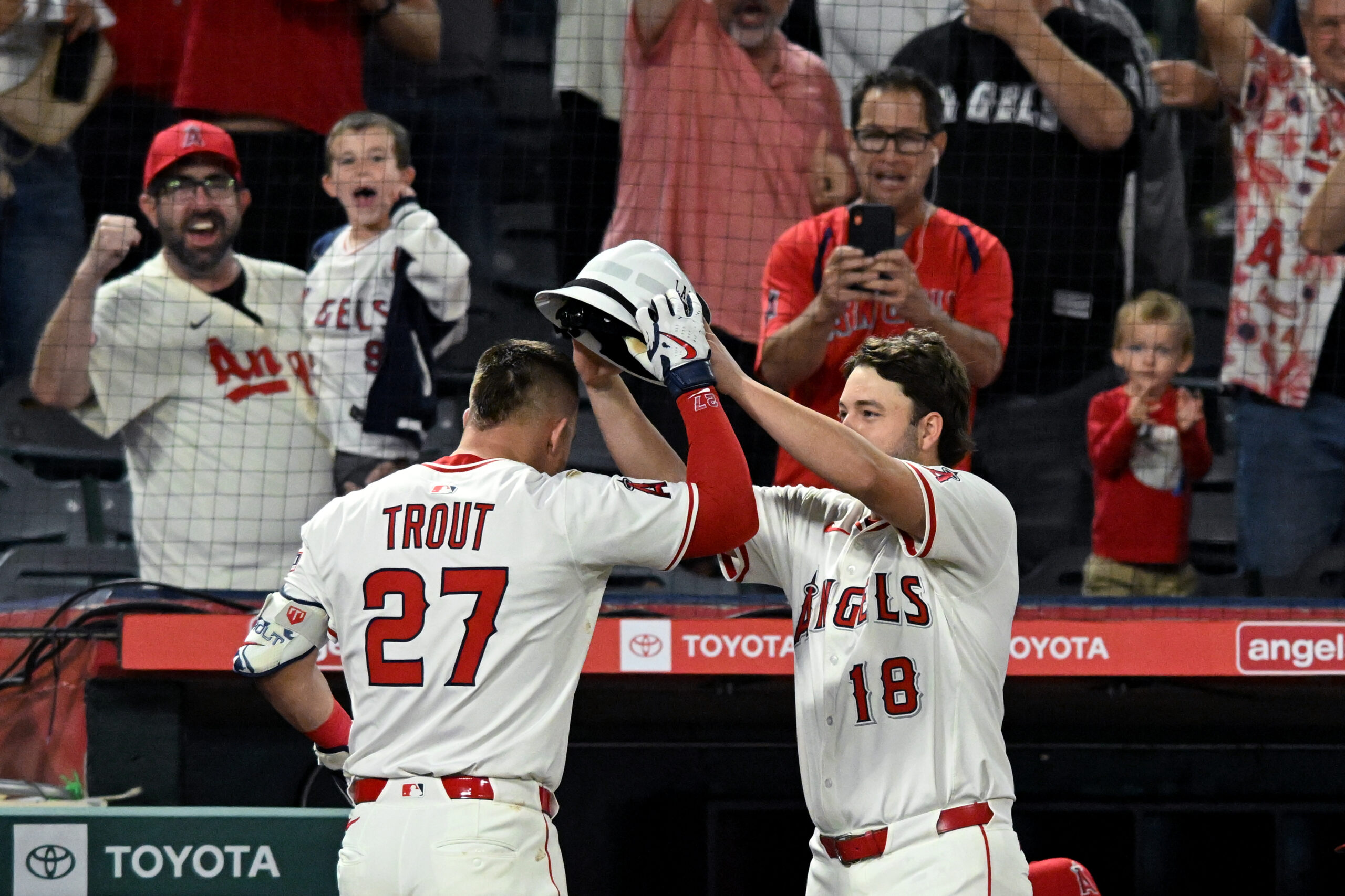 Angels star Mike Trout, left, receives a fire fighter’s helmet...