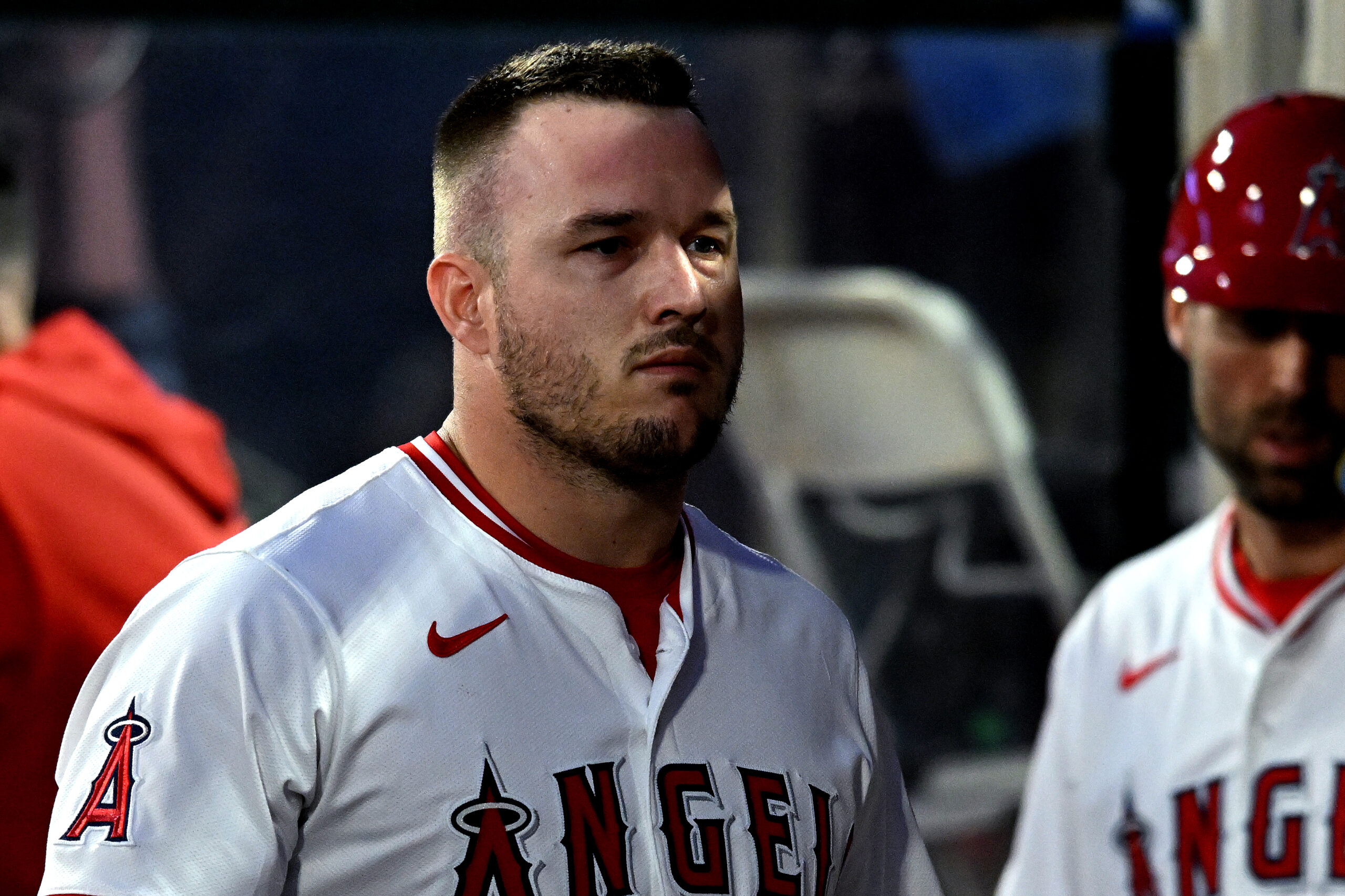 Angels star Mike Trout walks back into the dugout after...