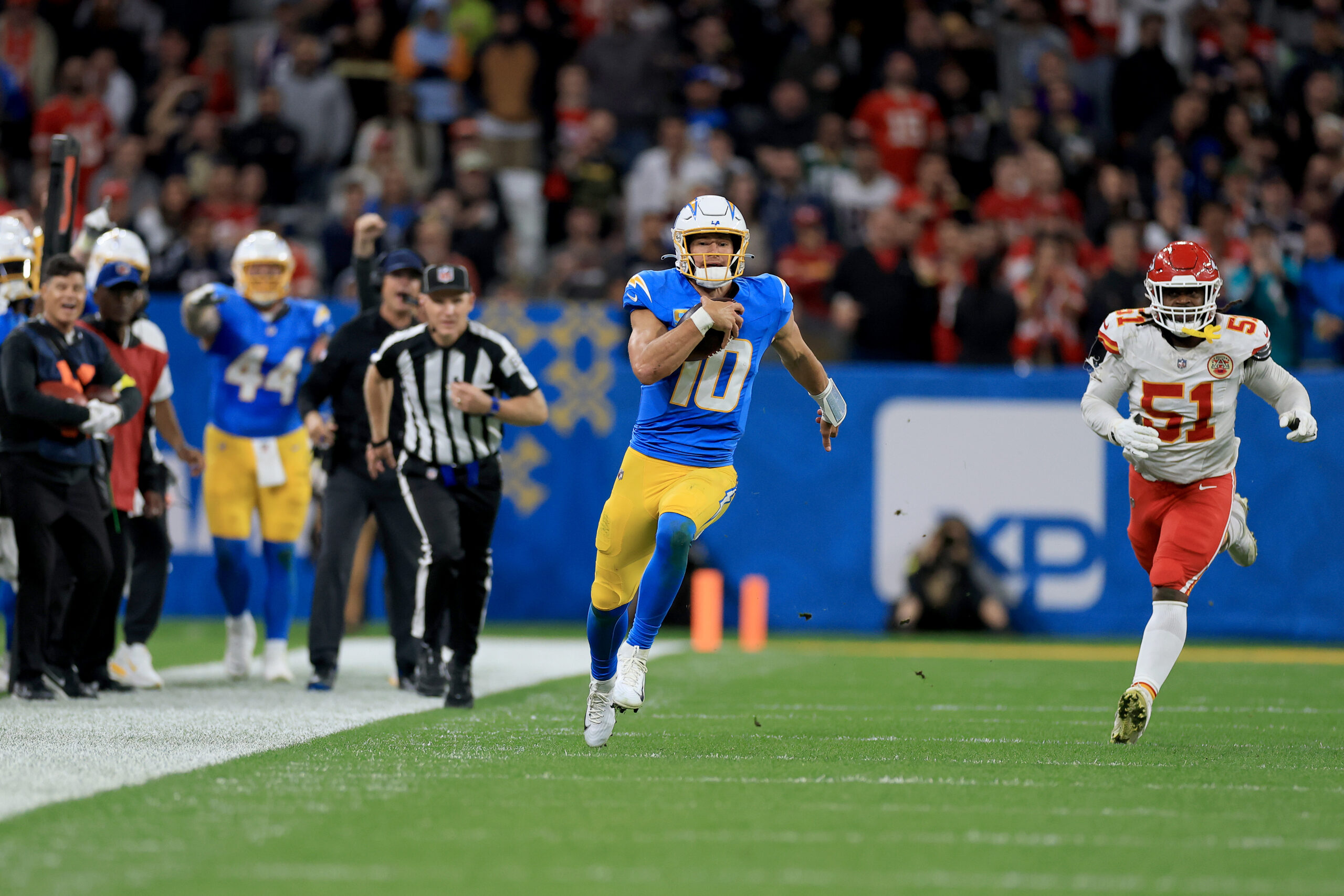 Chargers quarterback Justin Herbert scrambles for a game-clinching first down...