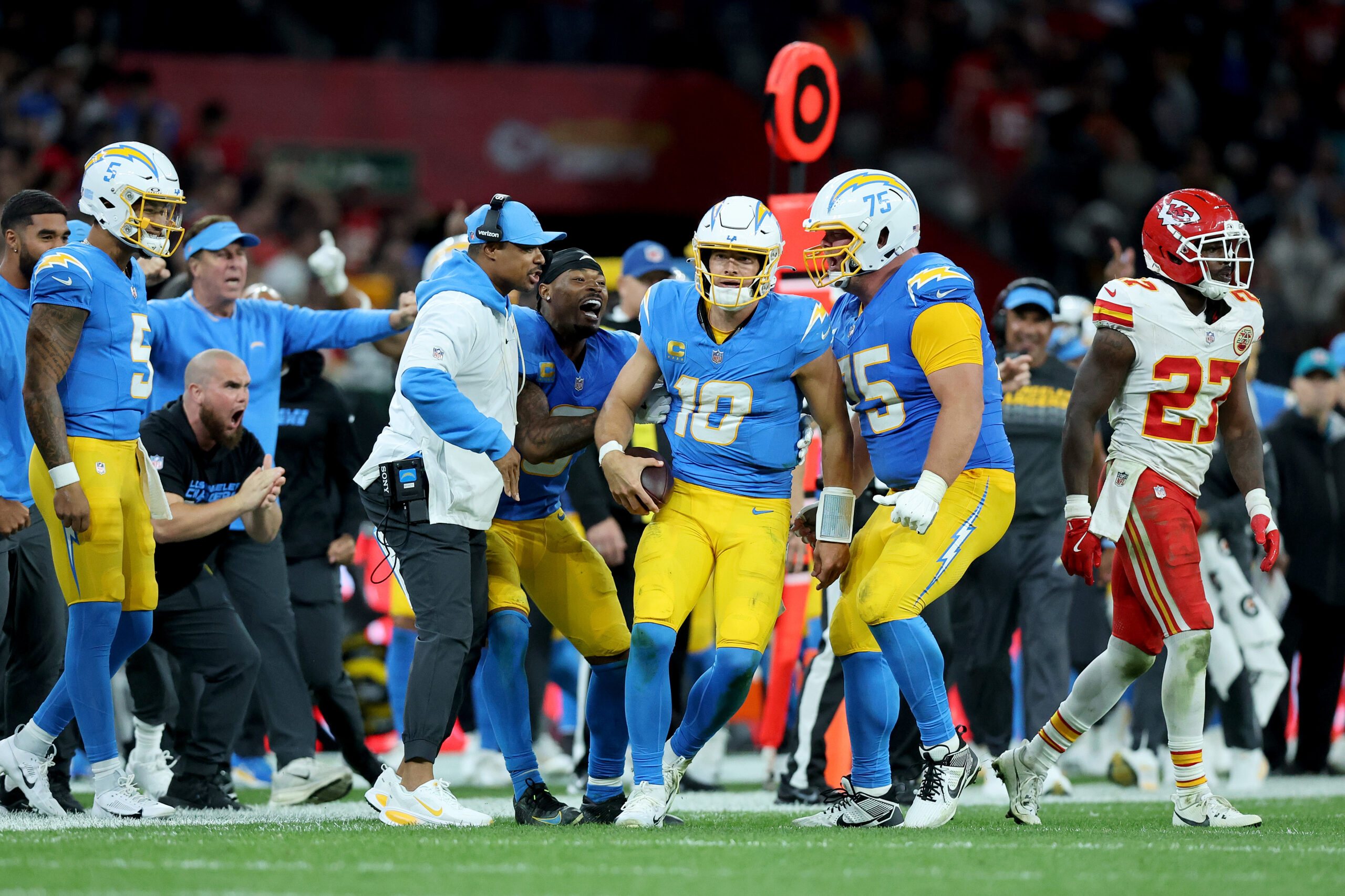 Chargers quarterback Justin Herbert (10) celebrates with teammates after running...