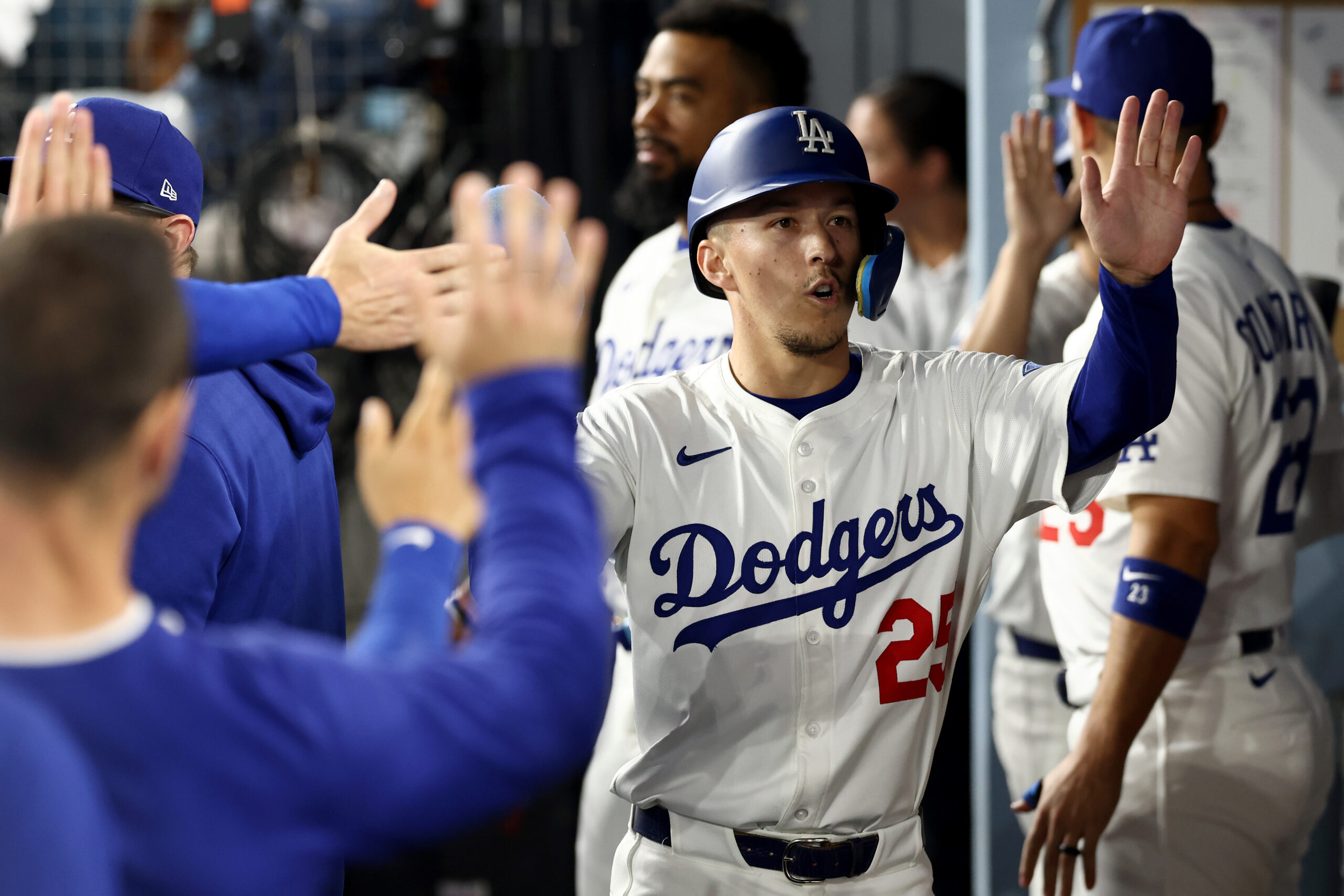 The Dodgers’ Tommy Edman celebrates with teammates in the dugout...