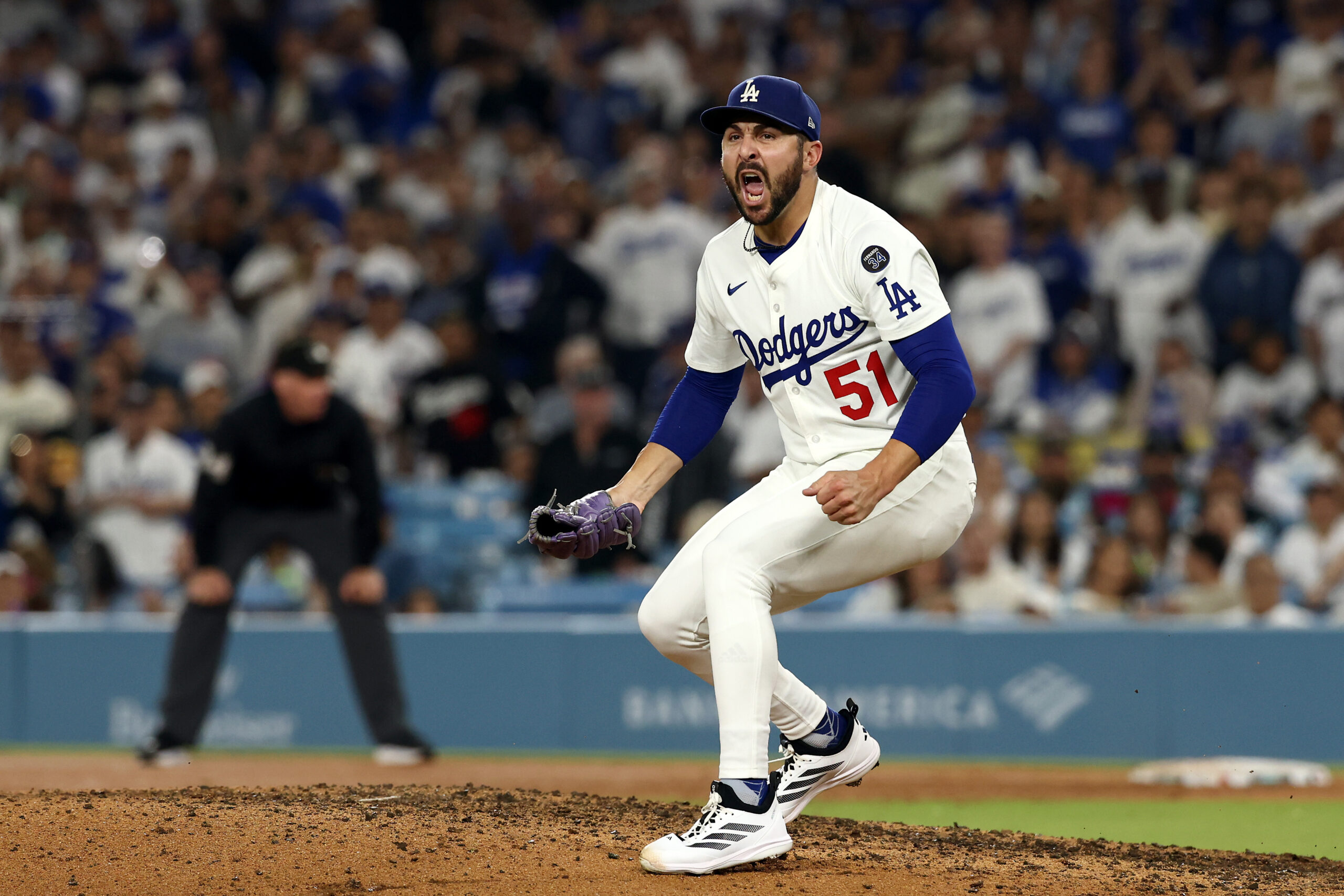 Dodgers relief pitcher Alex Vesia reacts after getting out of...