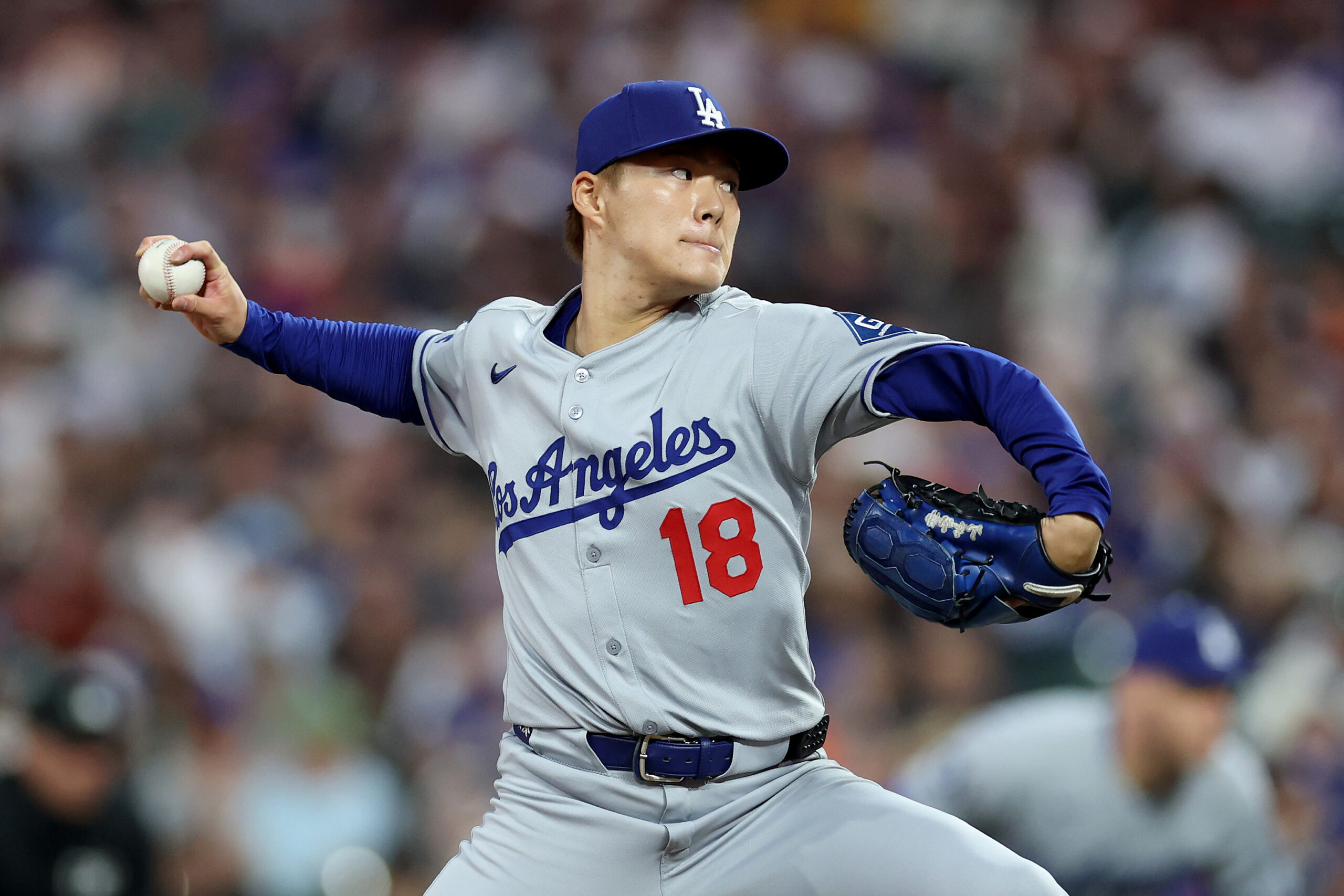 Dodgers starting pitcher Yoshinobu Yamamoto throws to the plate during...